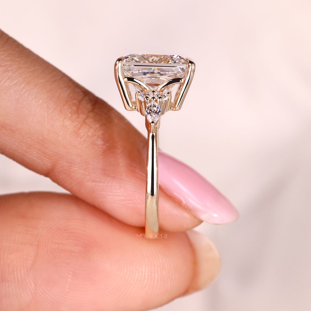 Princess cut ring with tapered shank and side stones.