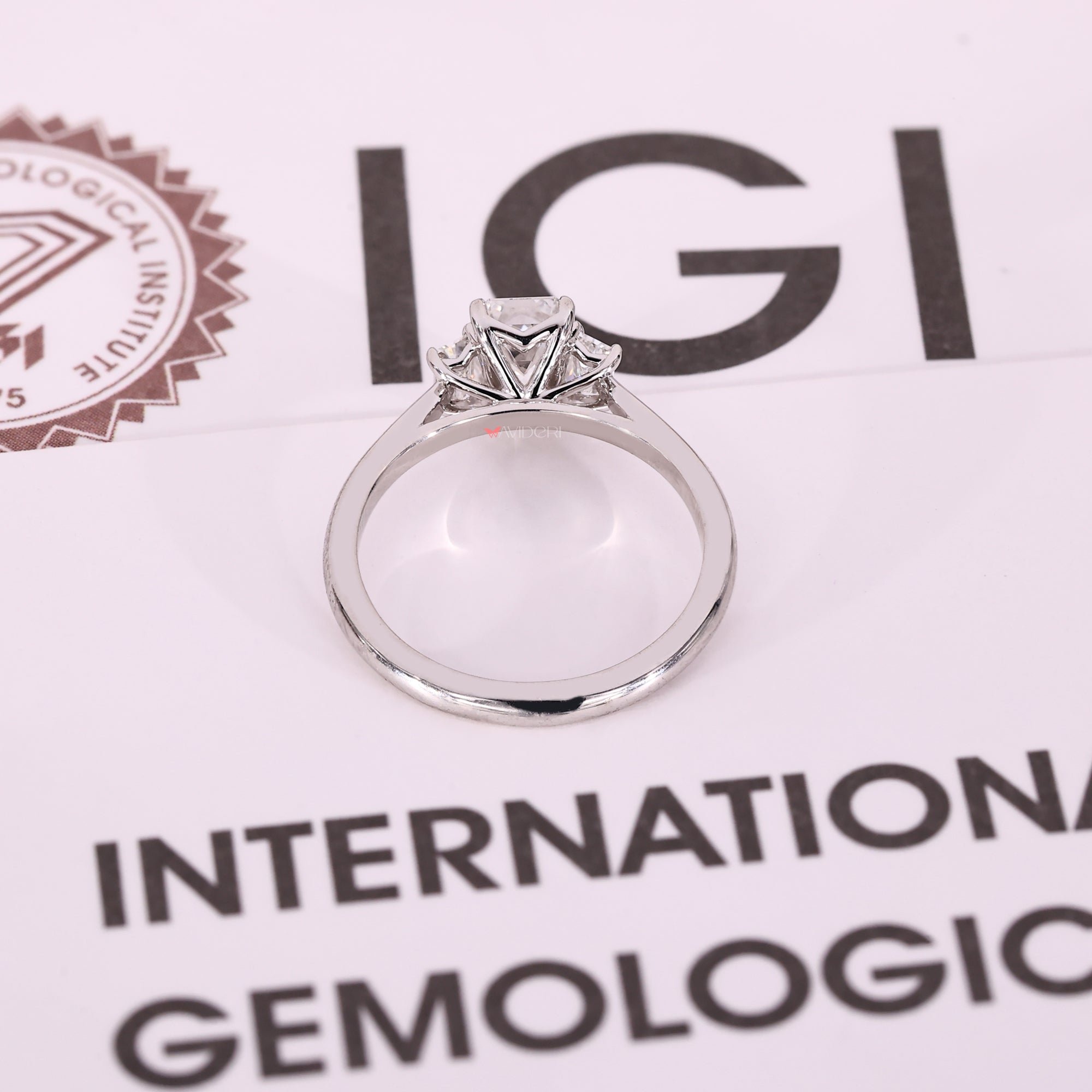 White gold 3 stone engagement ring with custom 4 prong claw setting.