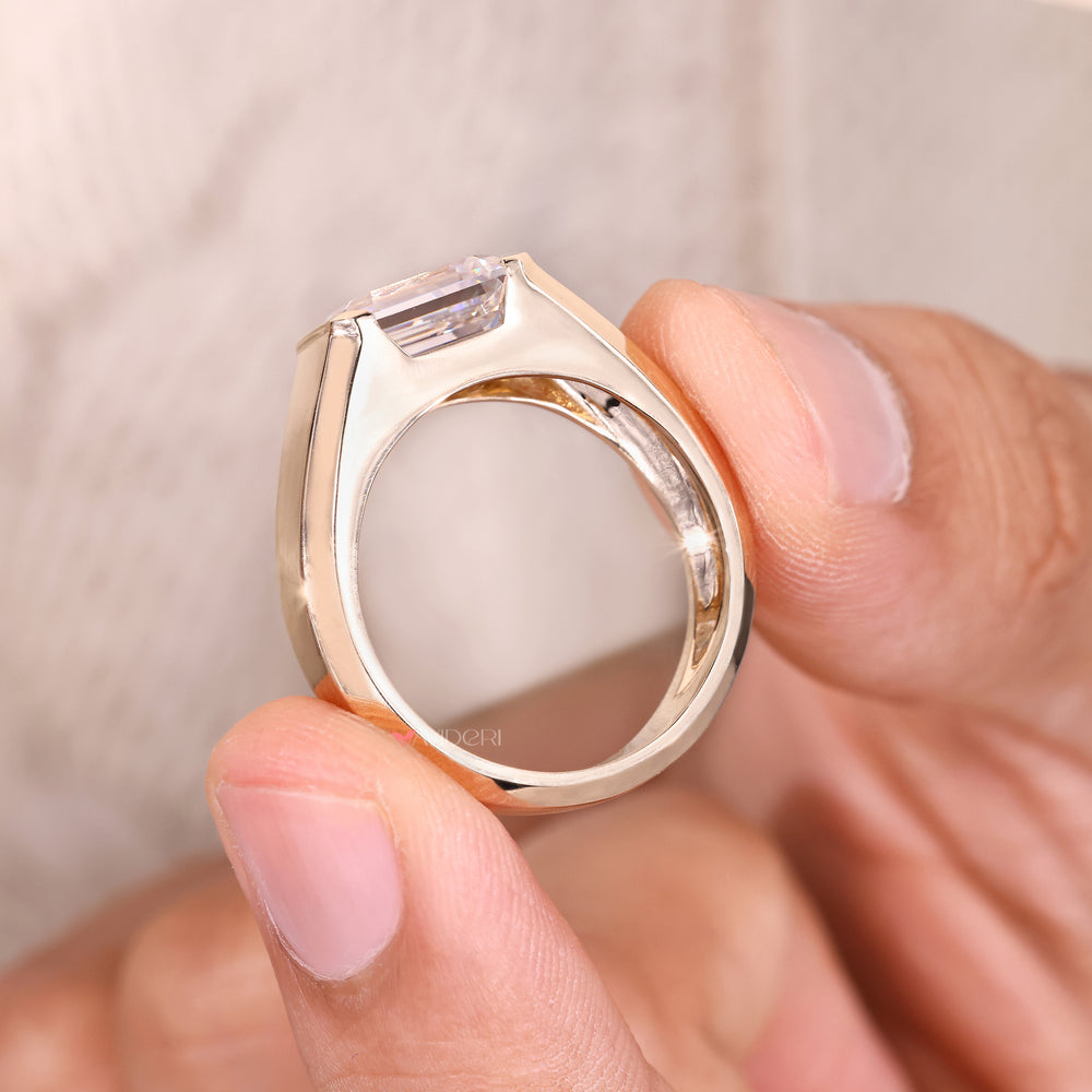 Emerald moissanite ring with bezel setting.
