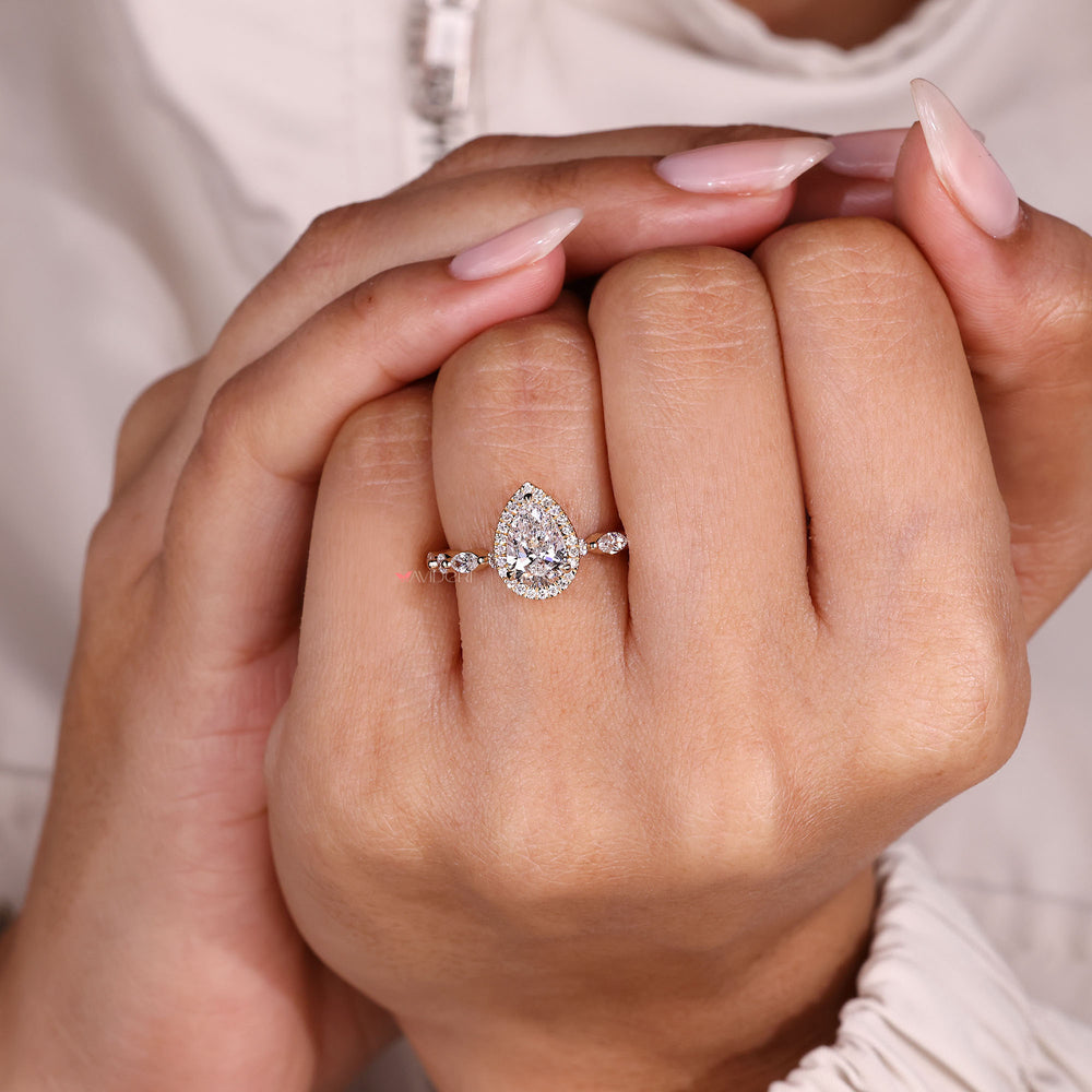 Handmade pear diamond ring with pave detail.
