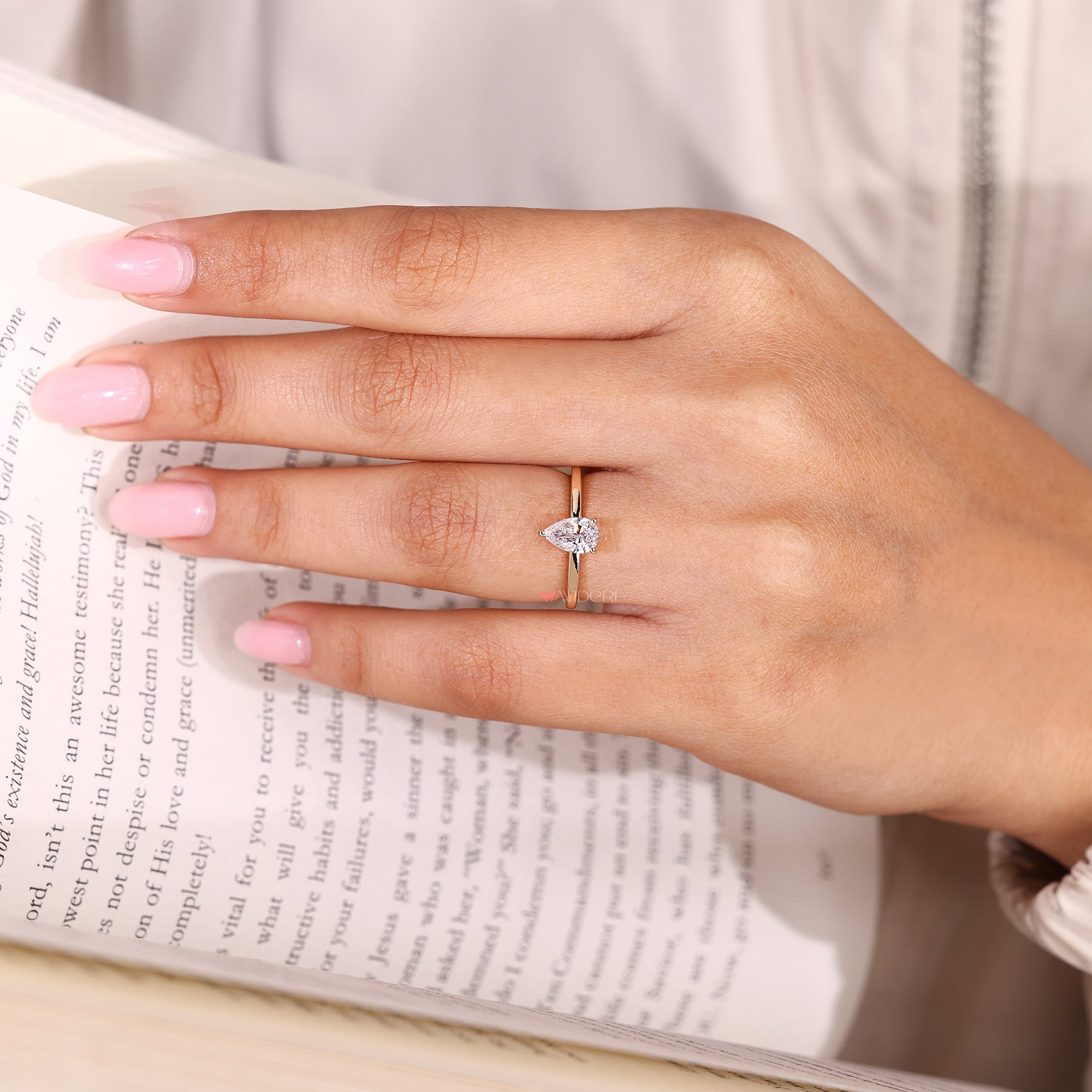 Pear cut diamond solitaire ring with three prongs.
