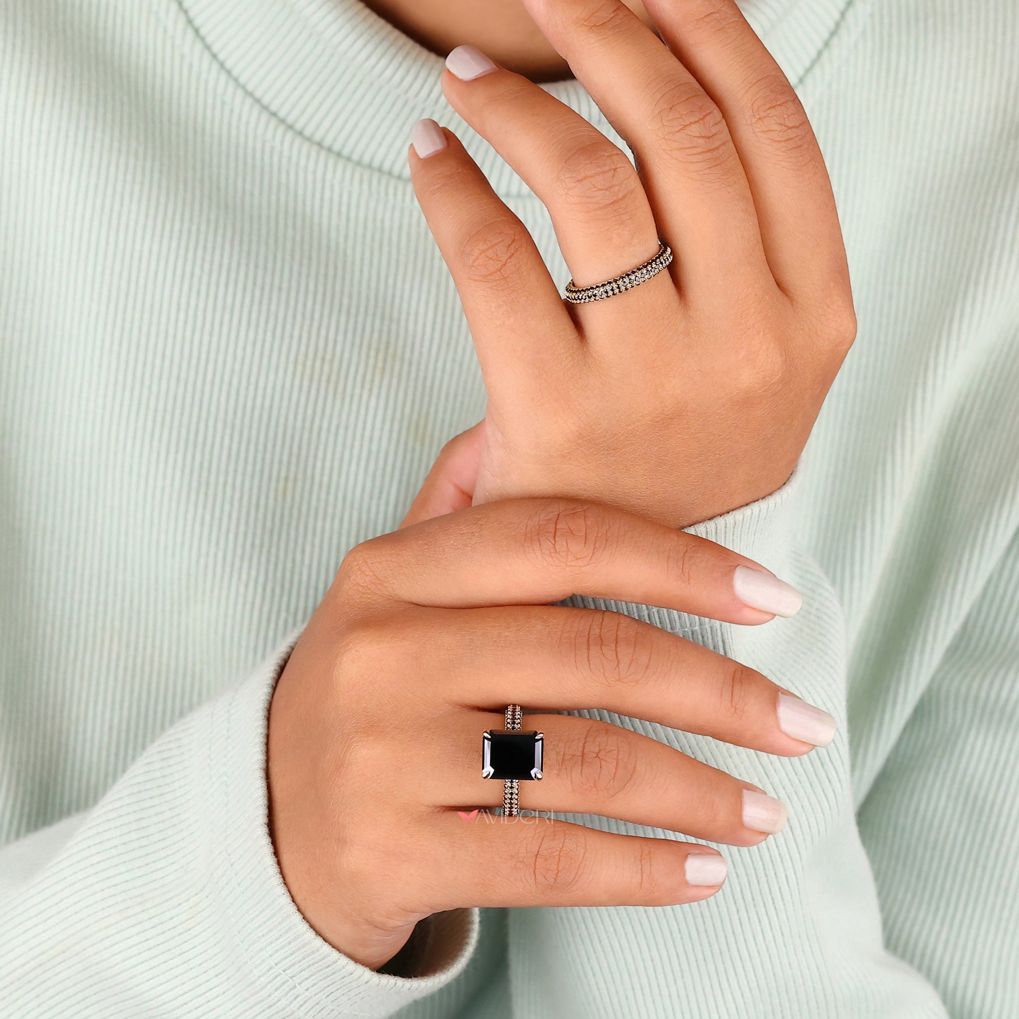 Round cut ring with a stunning emerald cut moissanite center stone.