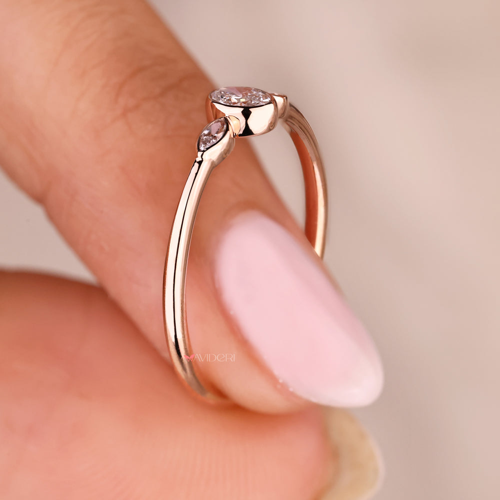 Three stone lab grown diamond ring with oval center stone.
