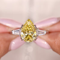 Pear Cut Center In Three Stone Moissanite Ring