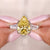 Three stone moissanite ring with Canary Yellow pear cut center and tapered baguette side stones.
