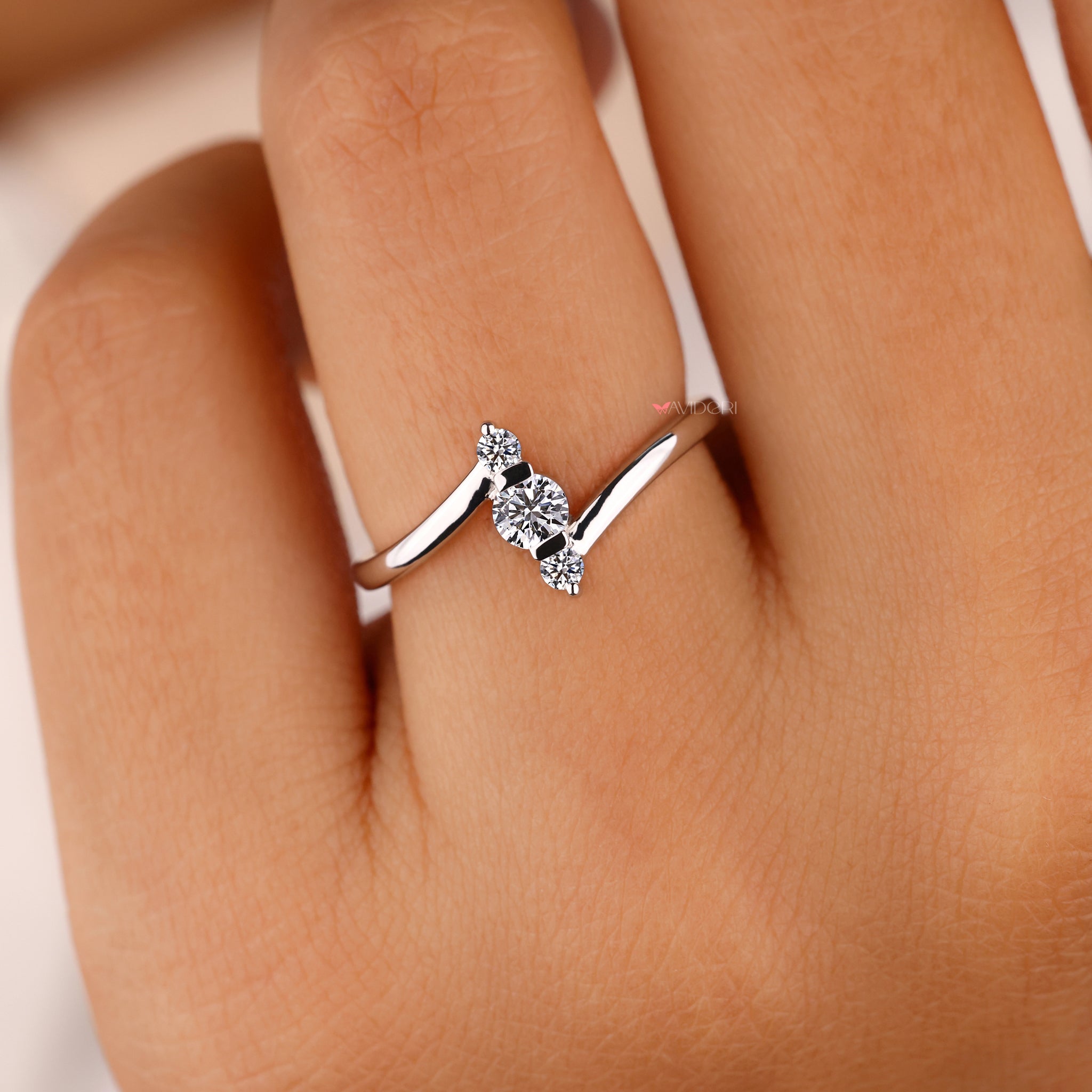 Three stone engagement ring with handmade jewelry.
