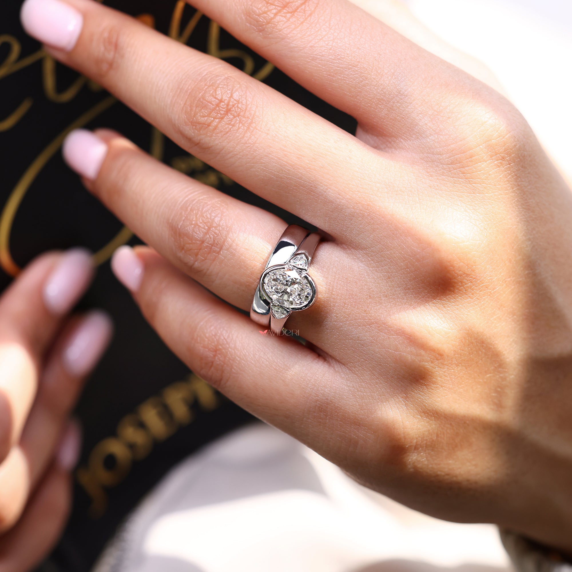 Three stone ring with half bezel set in white gold.