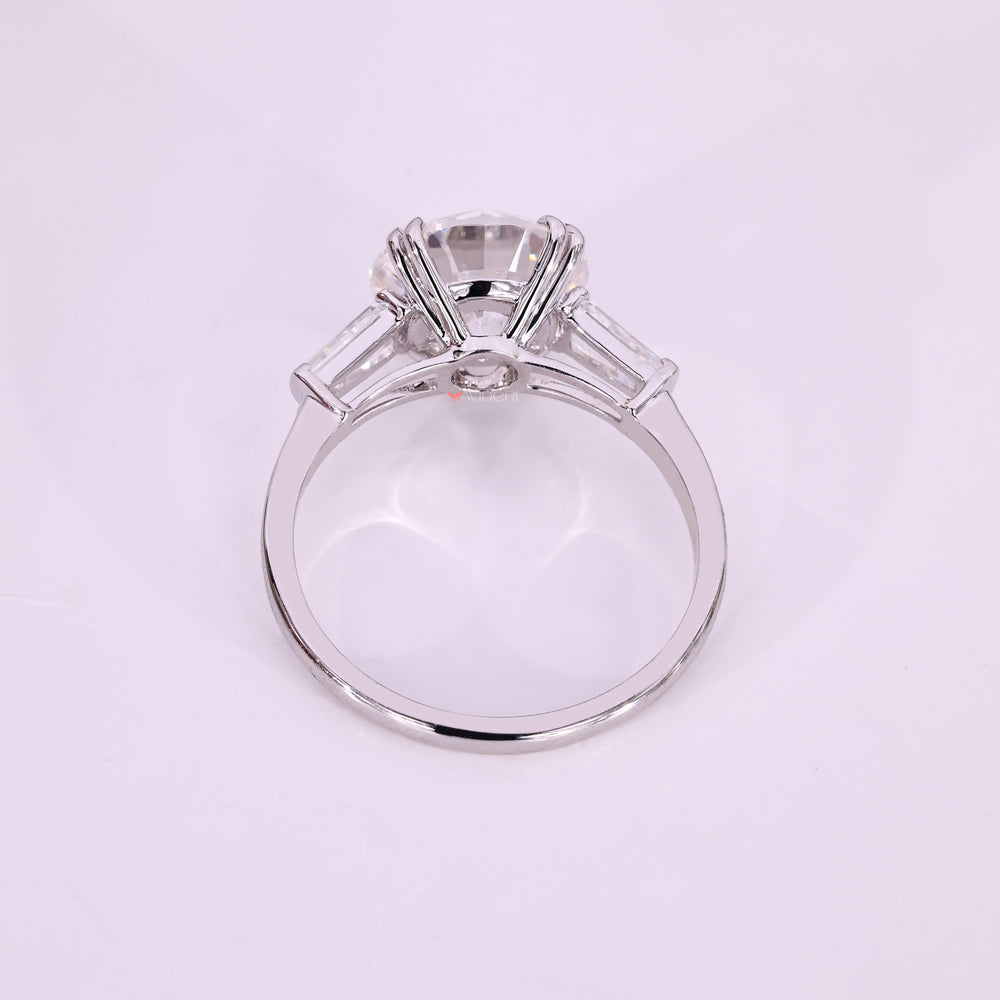 Handmade round moissanite ring with side stones.
