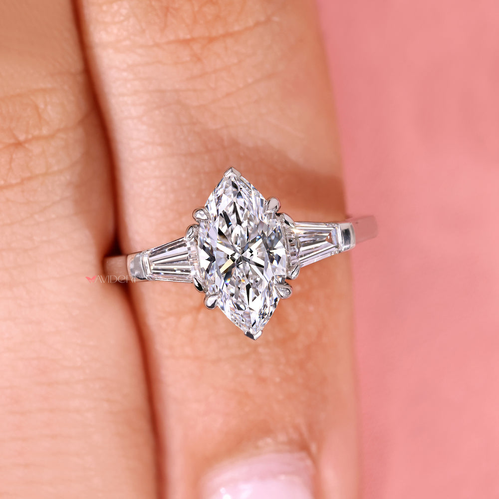 Marquise ring with tapered baguette three stone.
