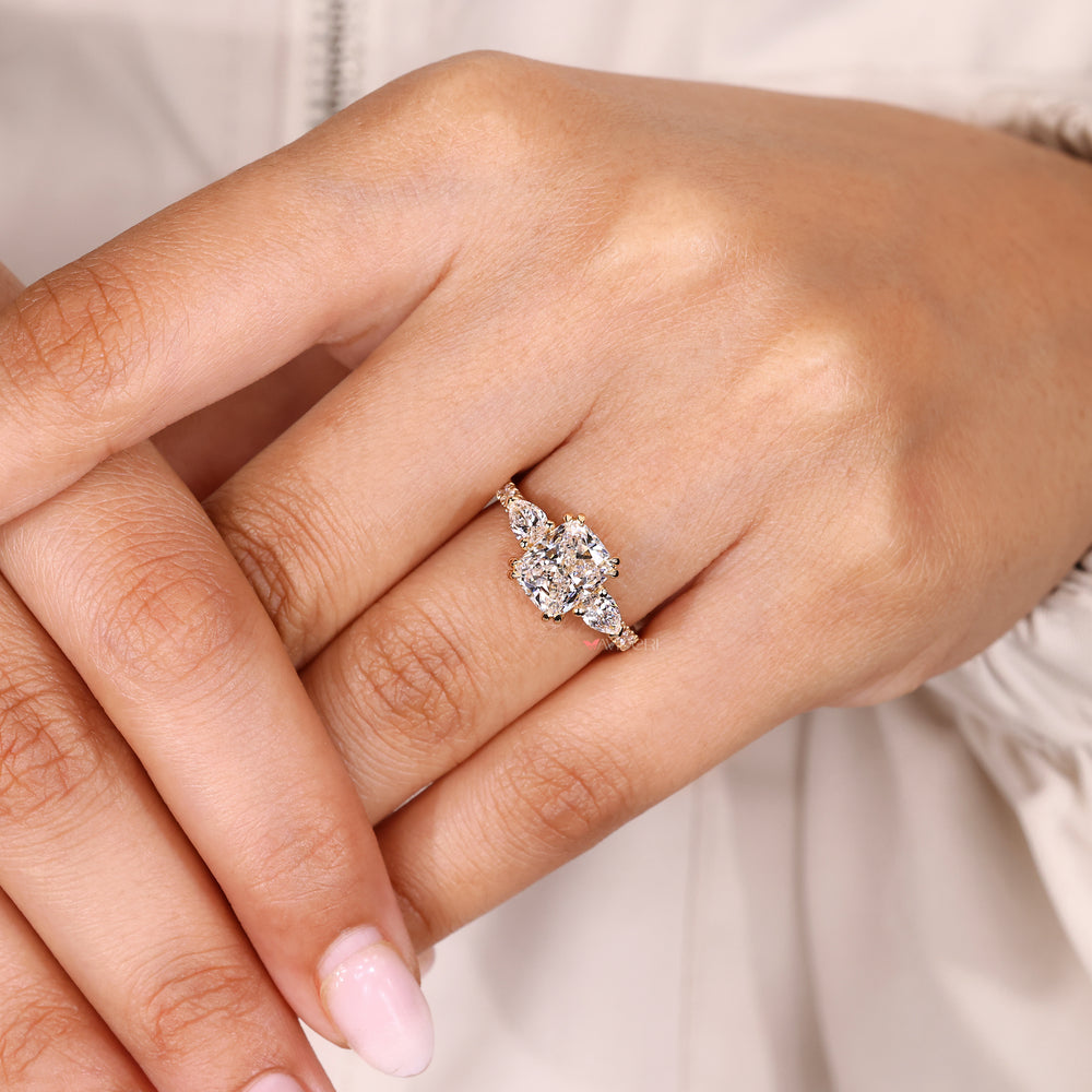 Handmade cushion diamond ring with side stones.
