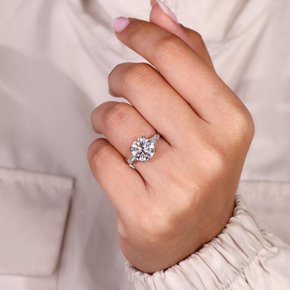 Round moissanite ring with double claw prong setting.
