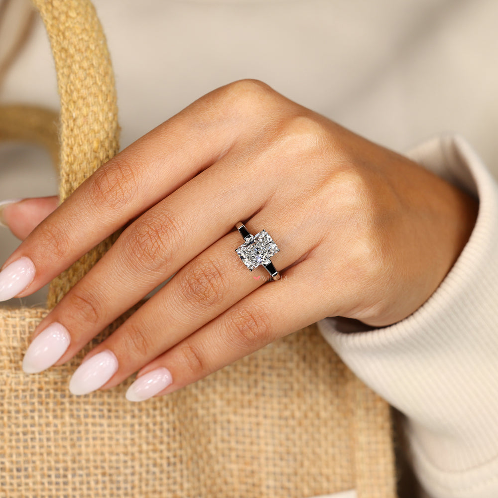 Black moissanite radiant cut three stone ring.
