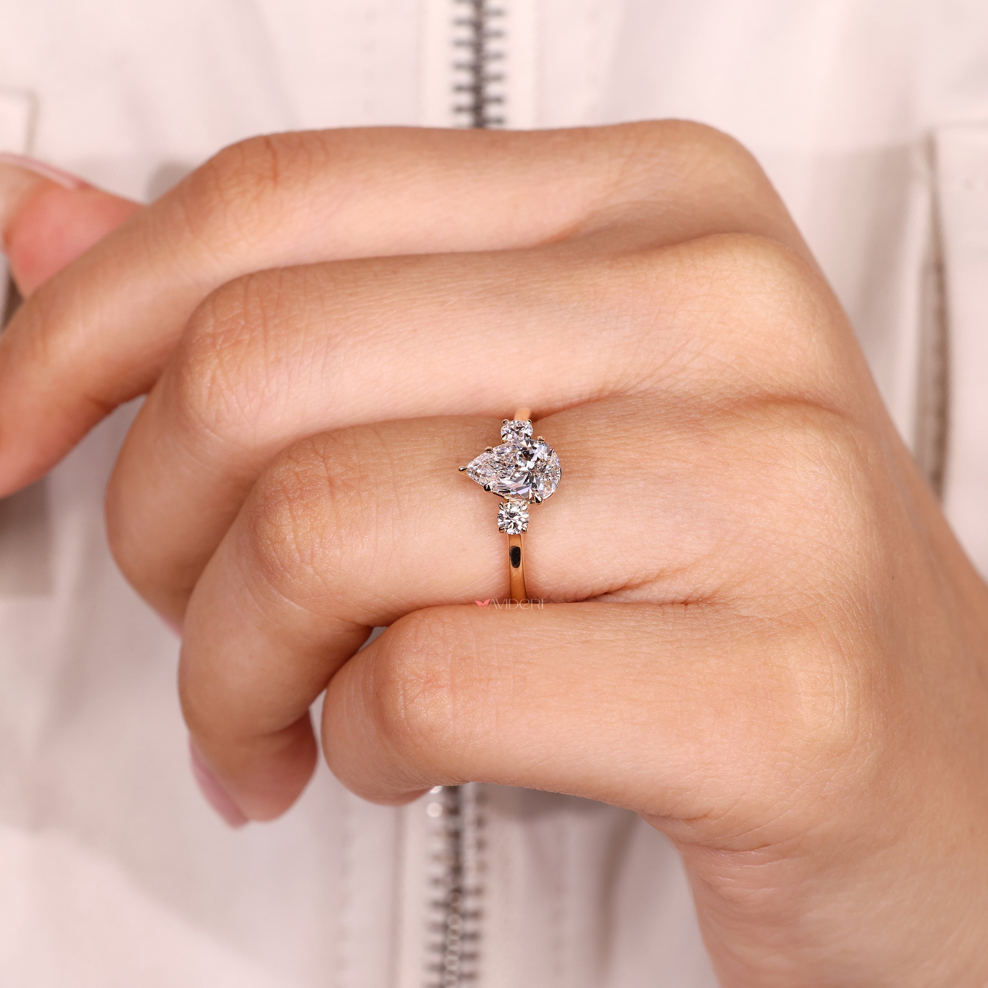 Handmade pear cut diamond ring with round side accents

