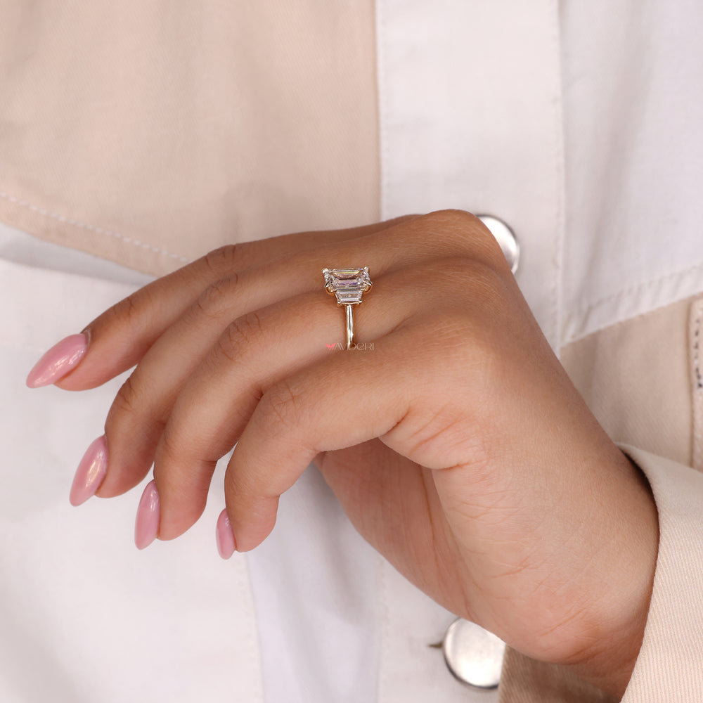 Emerald cut diamond ring with a three stone engagement ring for extra brilliance.
