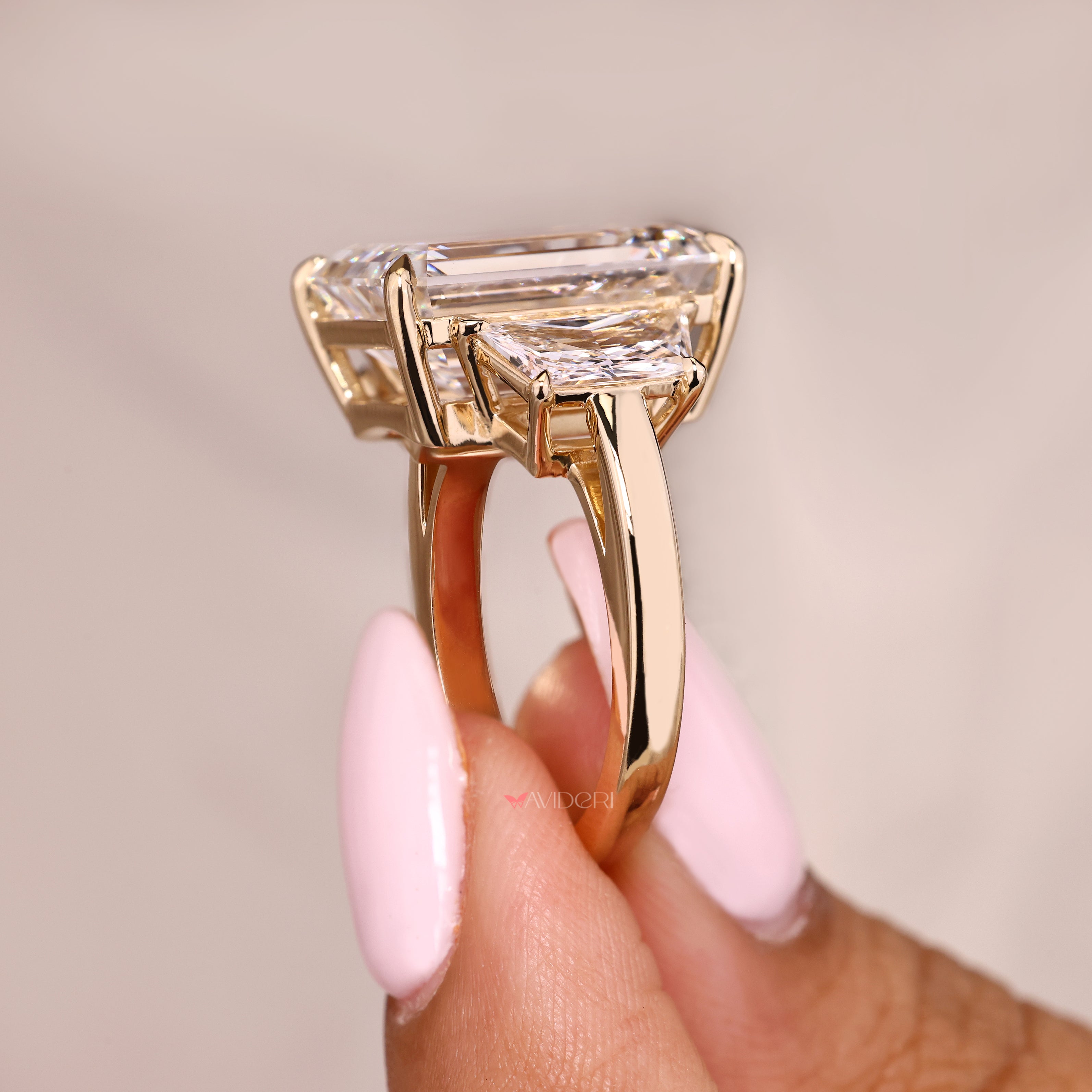 IGI certified emerald ring with trapezoid step side stones
