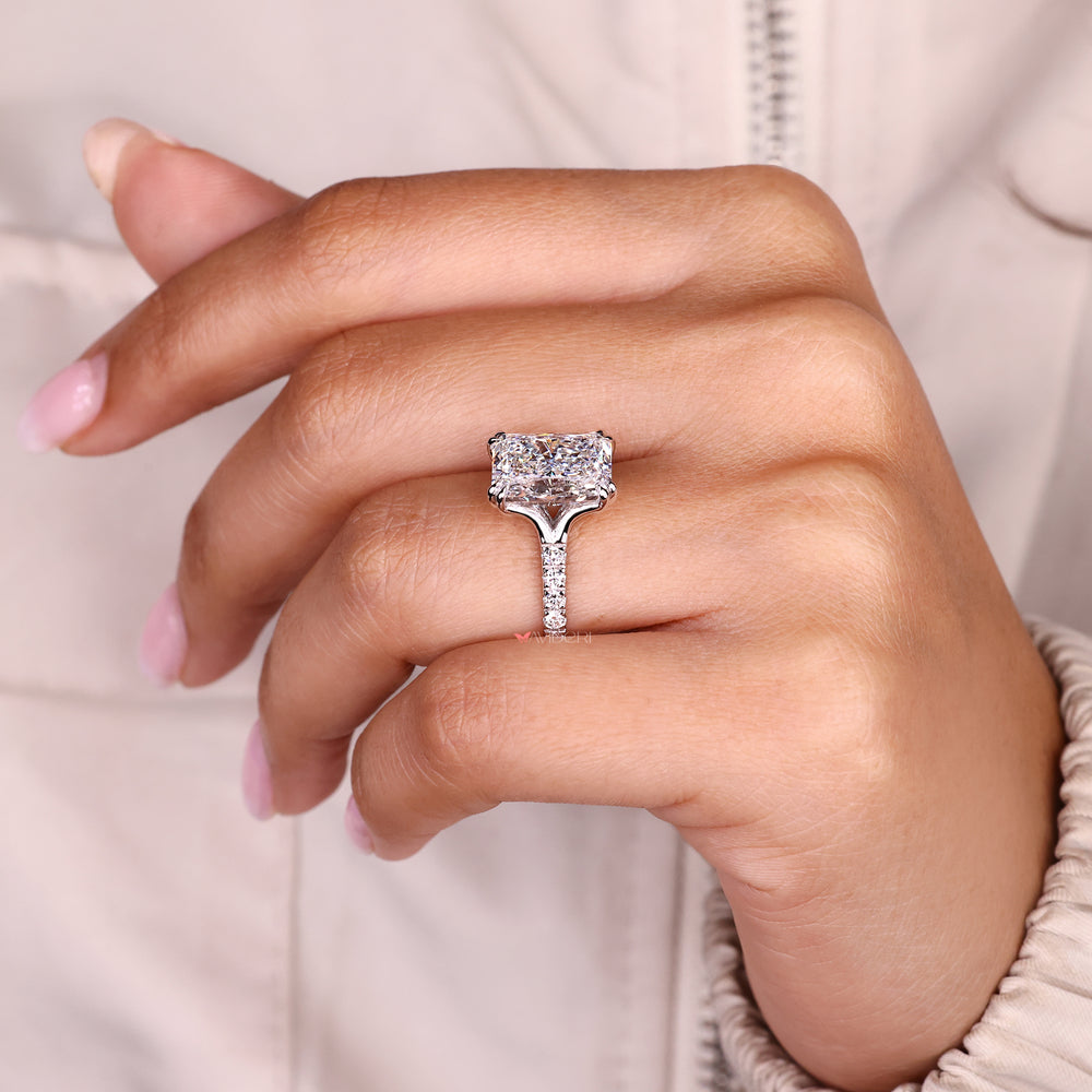 Radiant cut diamond ring with double claw prong setting.

