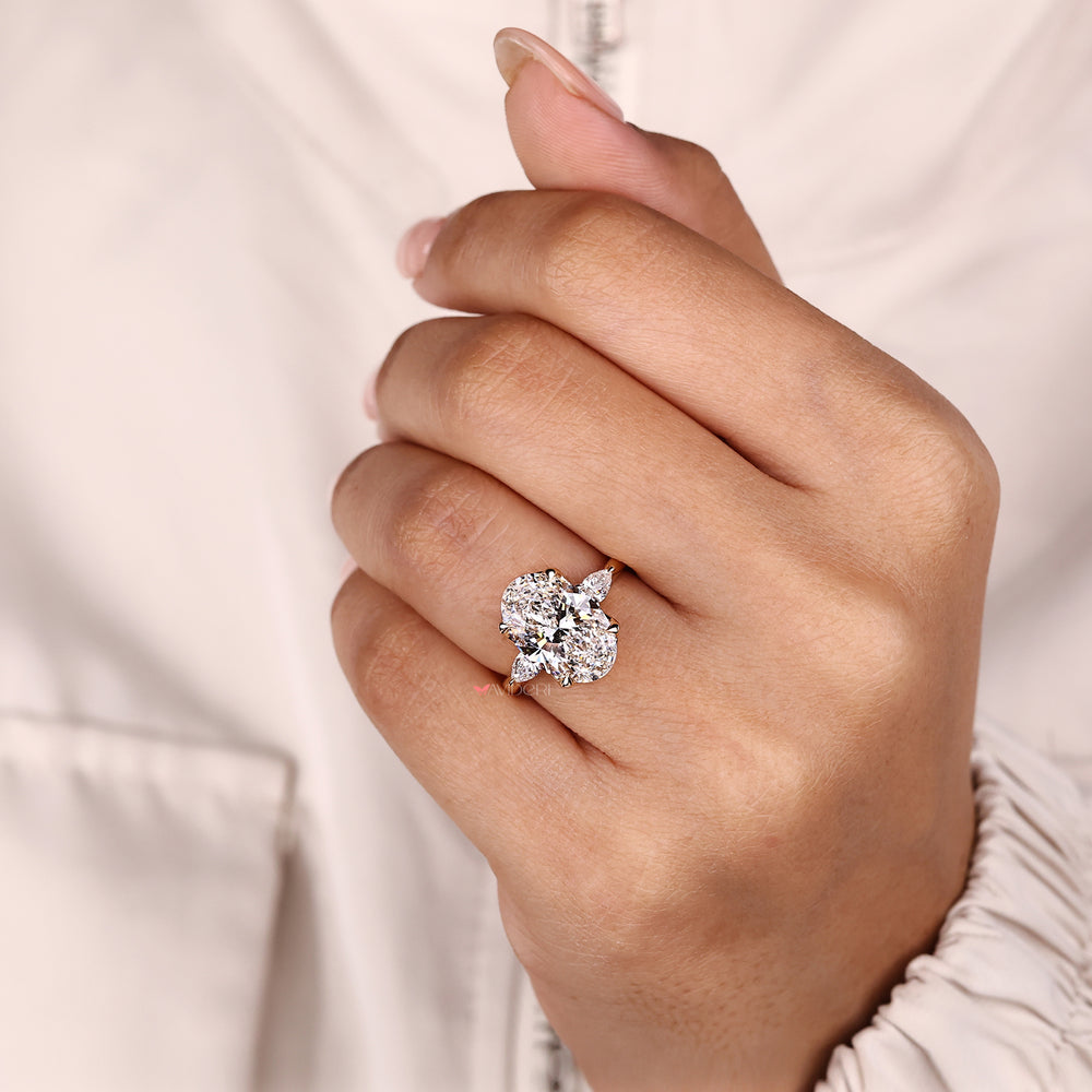 Lab grown oval diamond ring with pear accents.
