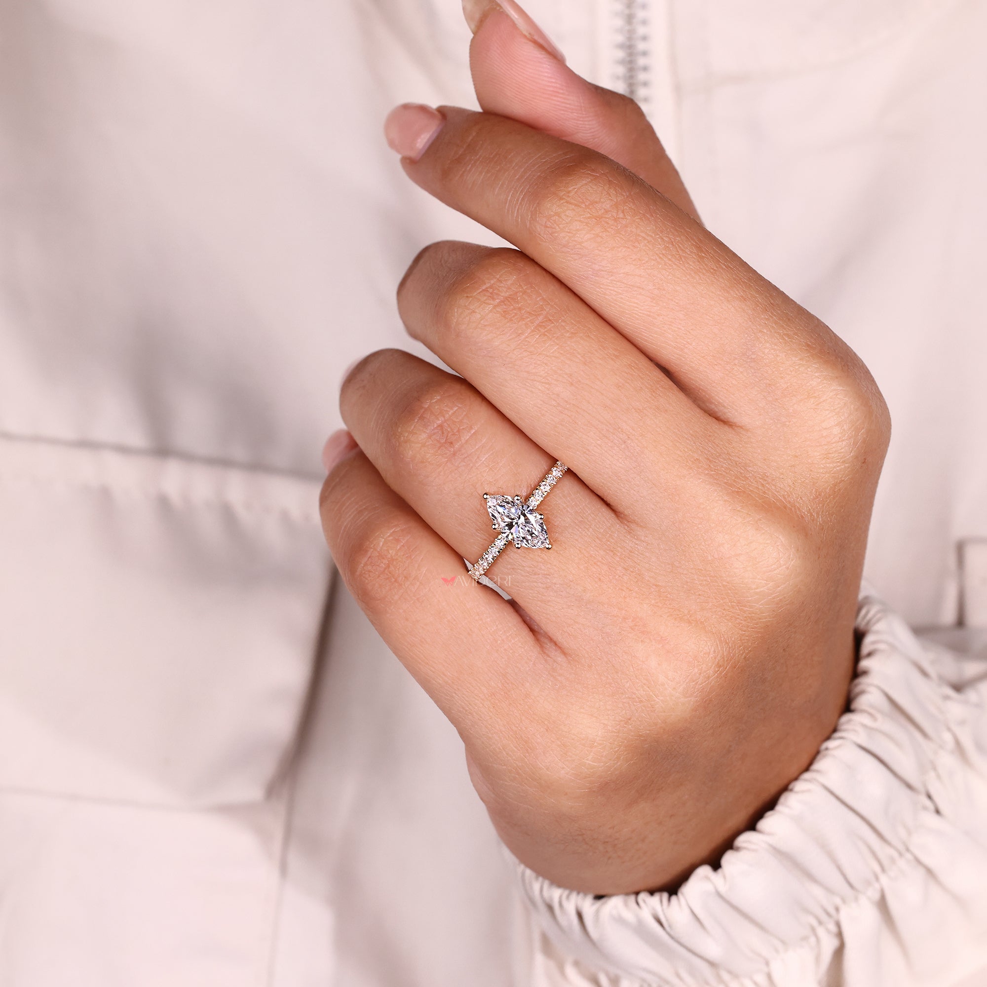 Marquise diamond ring with sparkling pave band.
