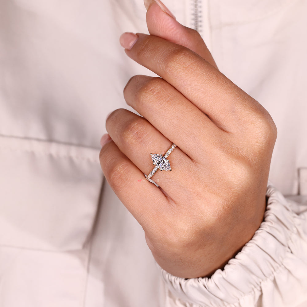 Marquise diamond ring with sparkling pave band.

