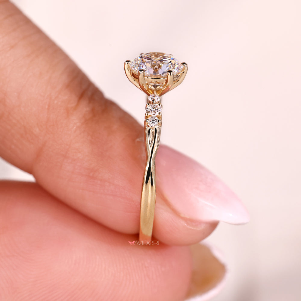 Twisted shank ring featuring a six prong round engagement ring setting and a round diamond for maximum brilliance.