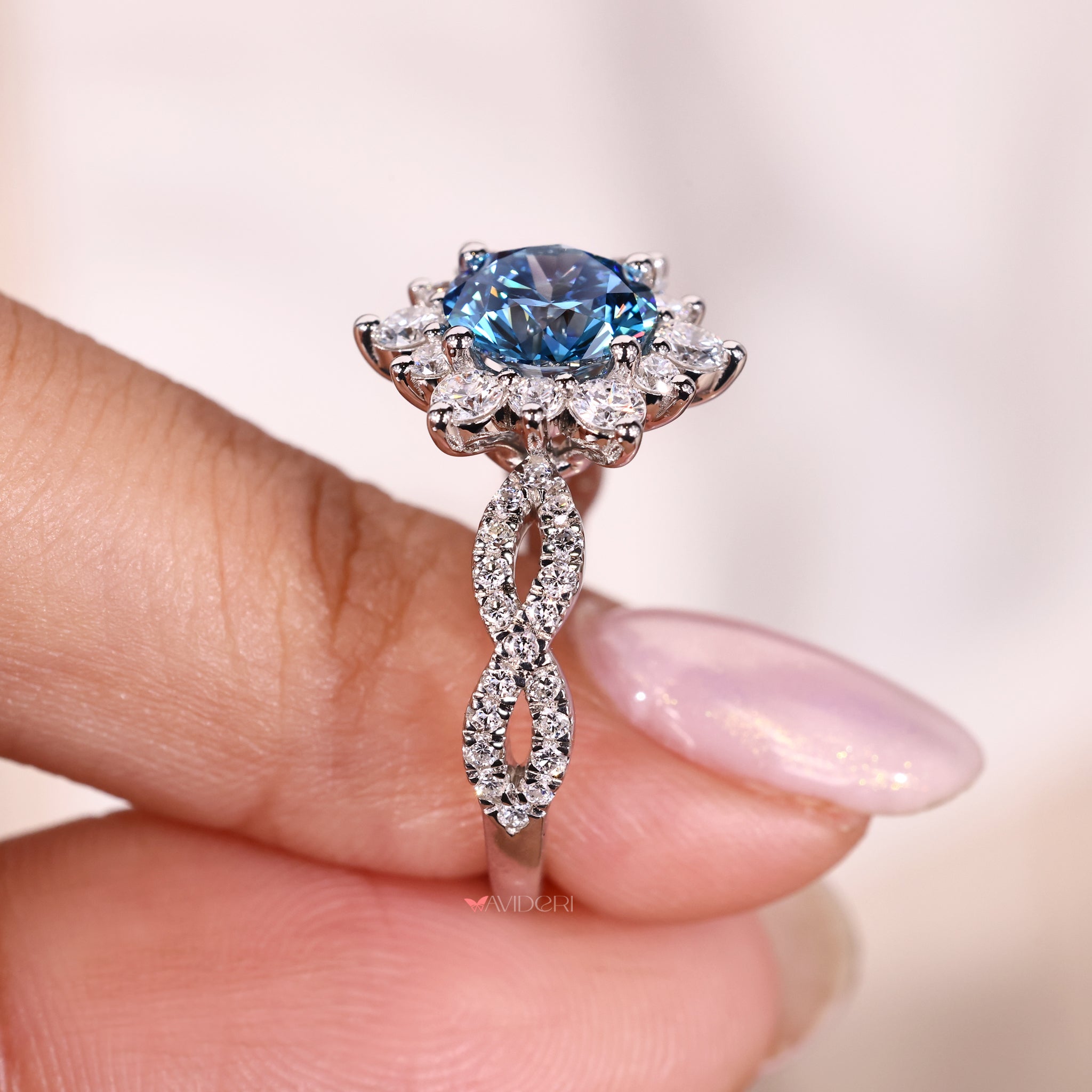 round diamond cluster engagement ring with prong setting and twisted pave band.