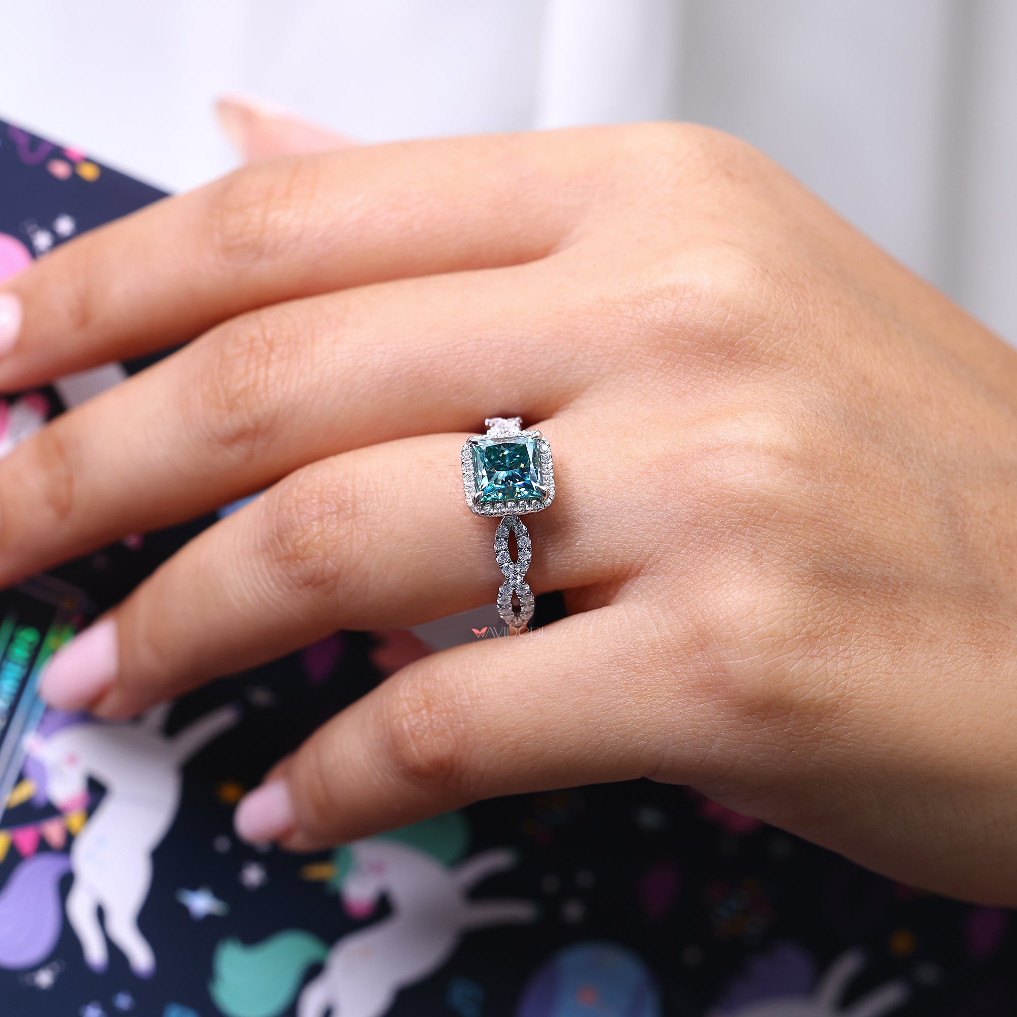 Princess cut halo engagement ring with a sparkling design.