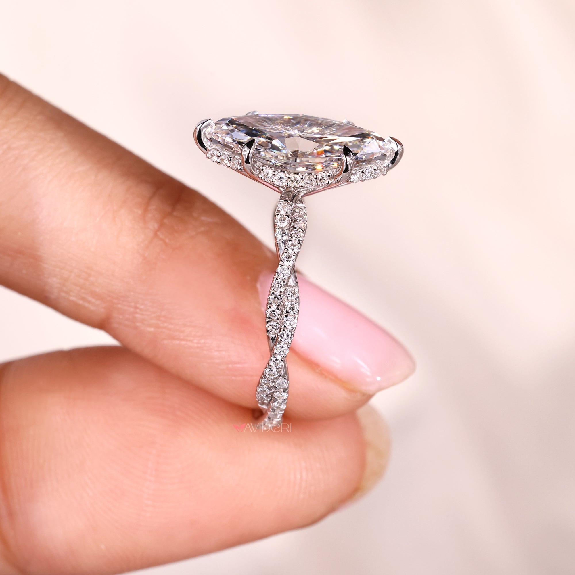 Hidden halo engagement ring with six claw prong setting.
