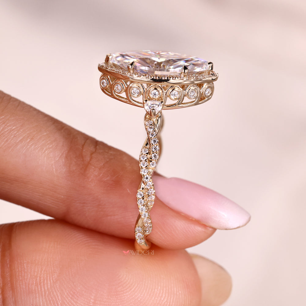Twisted shank vintage marquise moissanite halo ring.