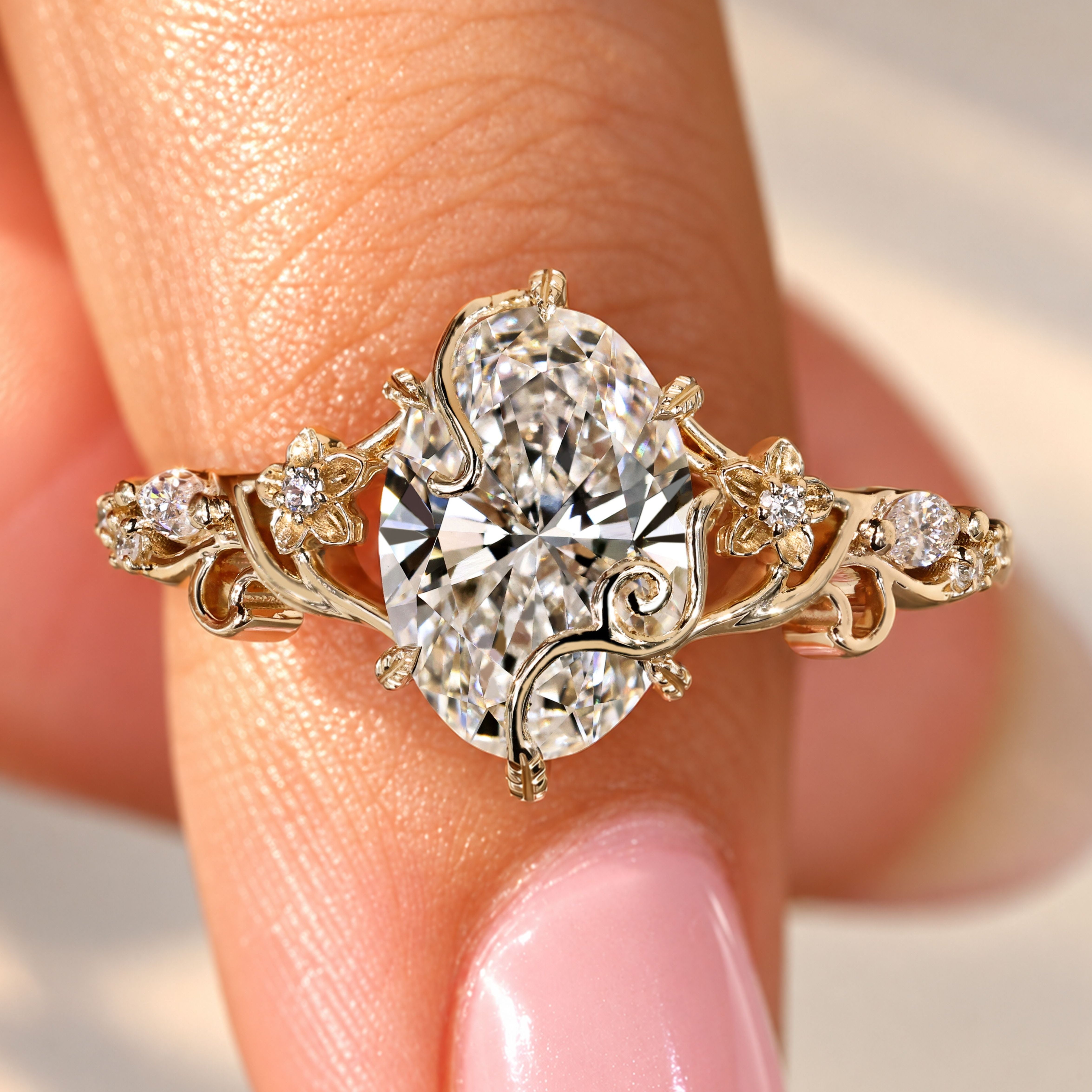 Oval cut diamond engagement ring with floral details.
