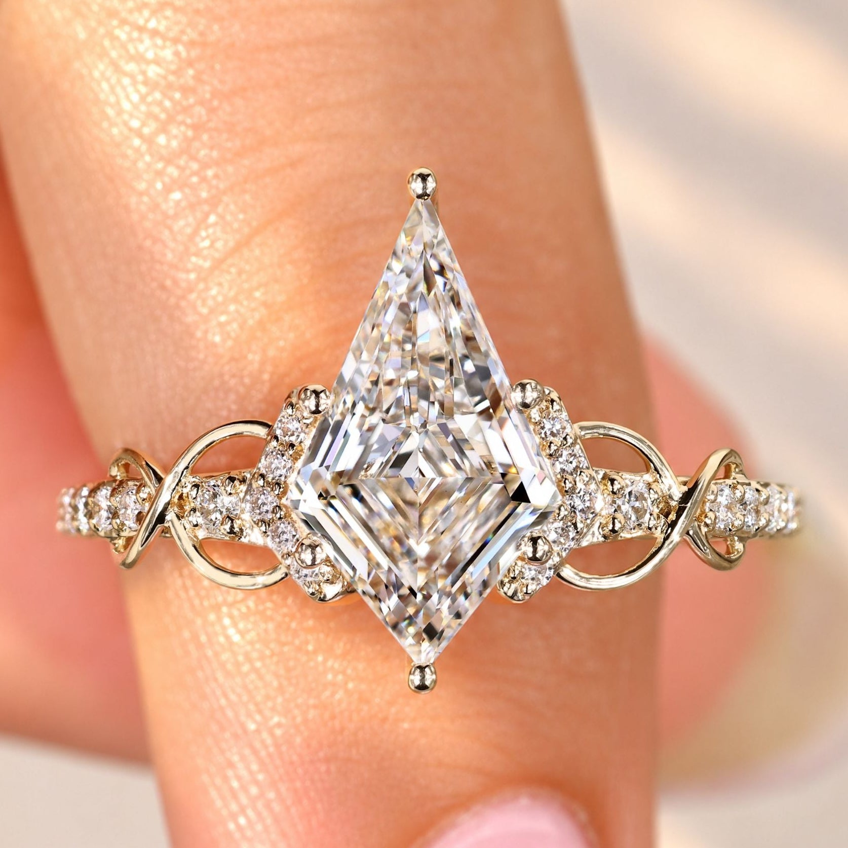Kite cut diamond ring with round diamond pave setting.
