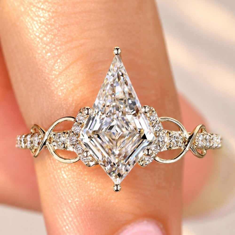 Kite cut diamond ring with round diamond pave setting.
