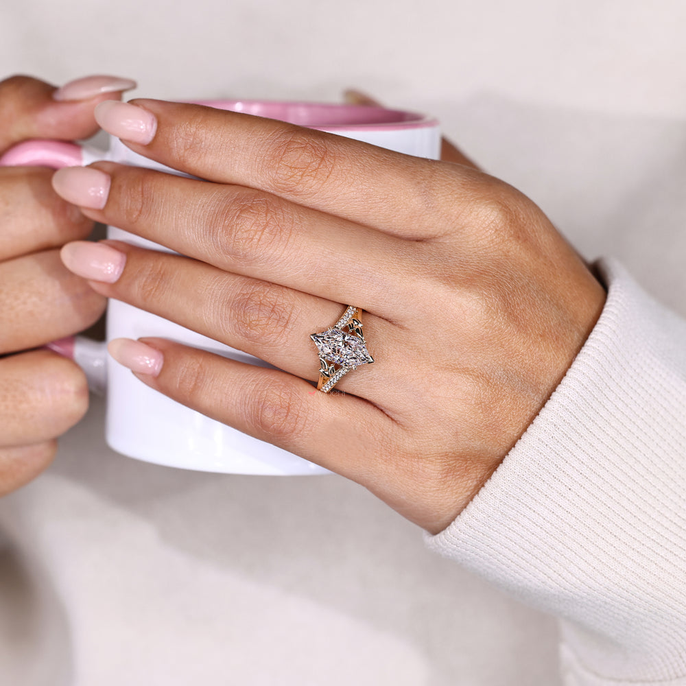 Marquise diamond ring with split shank setting.
