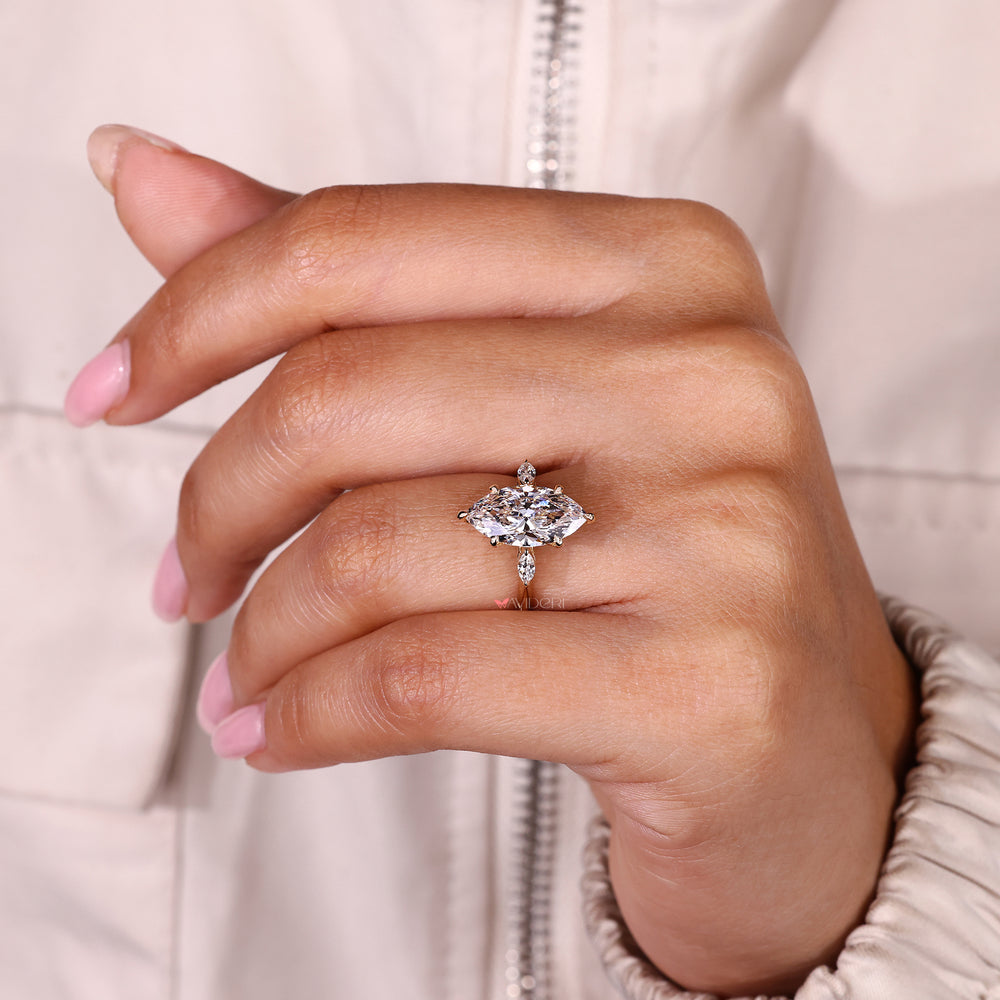 Three stone diamond ring with six claw prong setting.