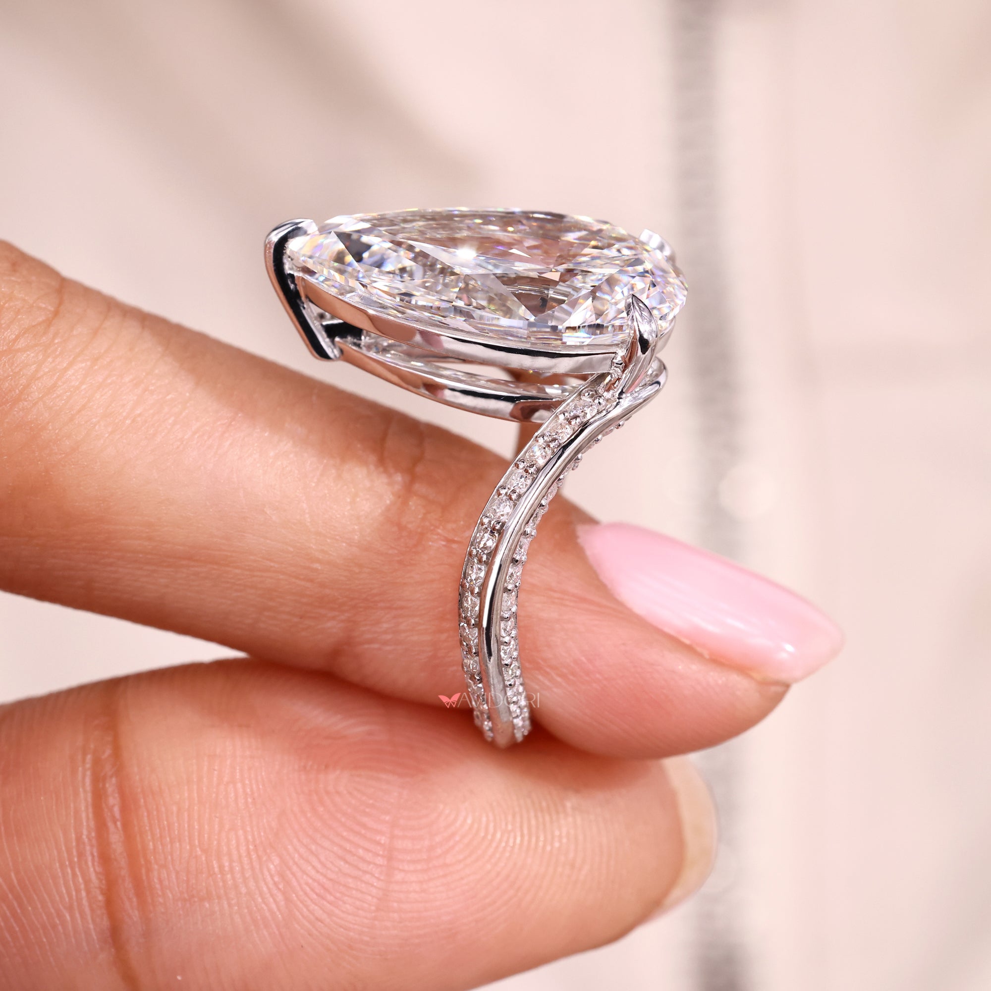 Round cut side stone with white gold engagement ring.
