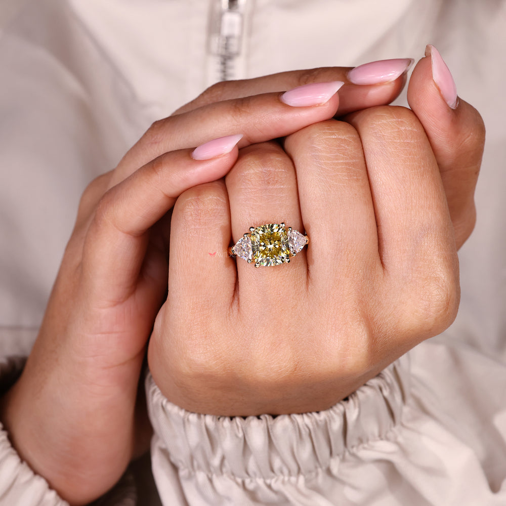 Canary yellow cushion cut moissanite ring three stone style.
