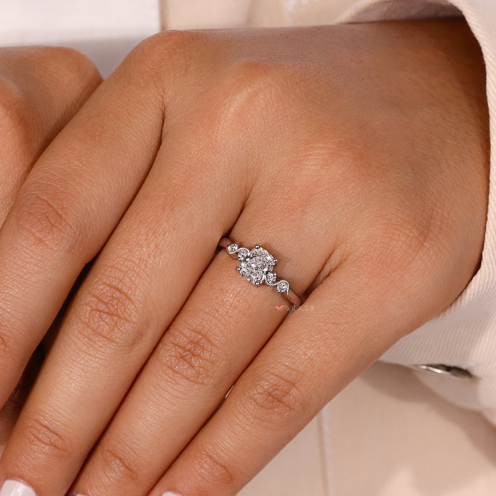 Cushion cut diamond ring with a prong setting ring.
