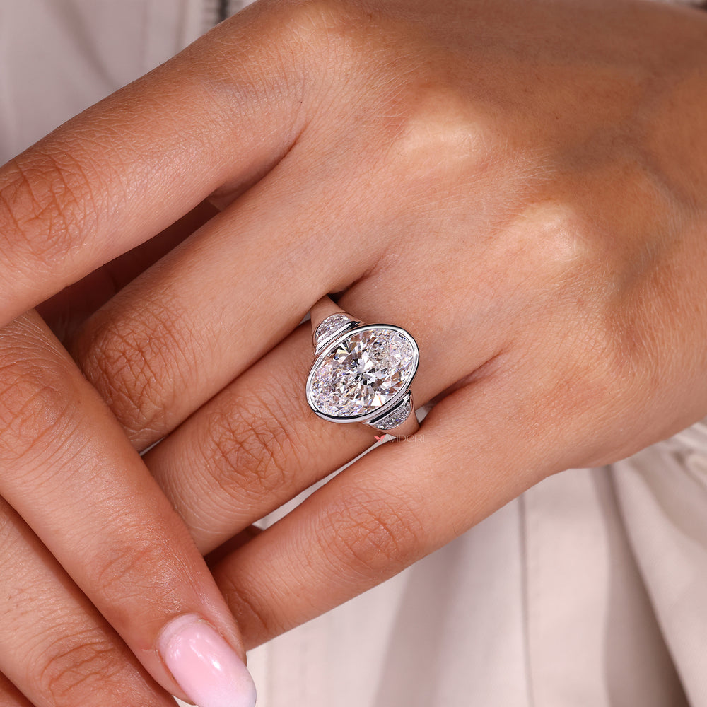 Lab grown diamond three stone engagement ring with oval center.