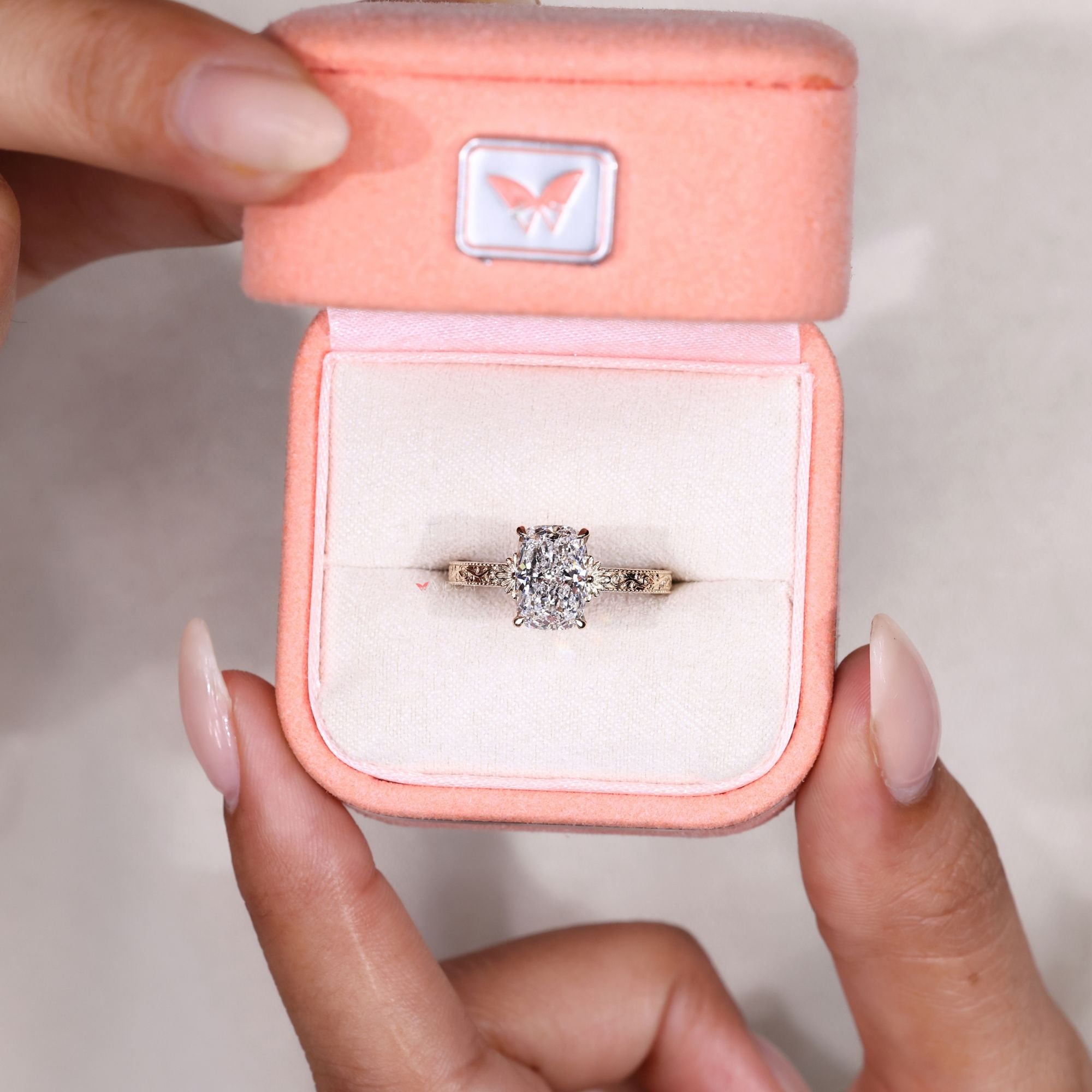 Vintage cushion diamond ring with scrollwork detail.
