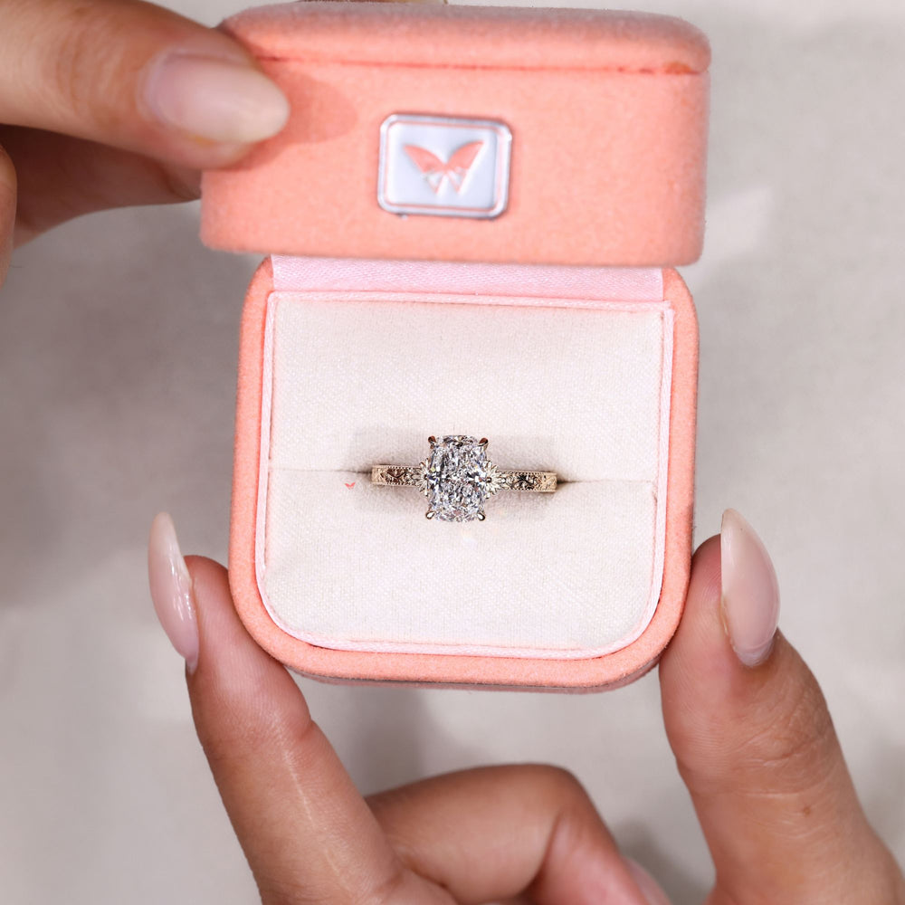 Vintage cushion diamond ring with scrollwork detail.
