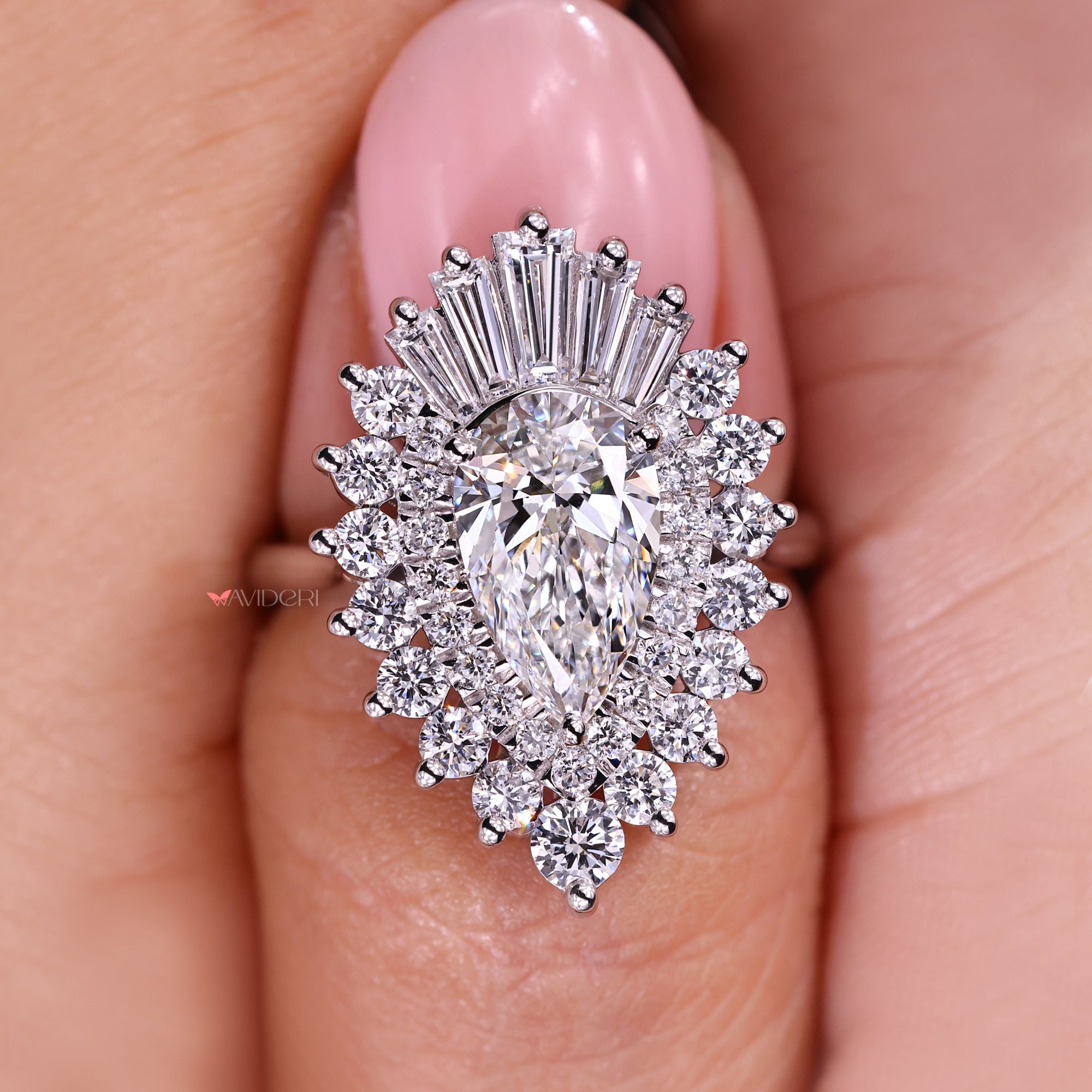 Diamond ring held between fingers with a blurred background