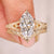 Vintage marquise ring with curved eternity band.
