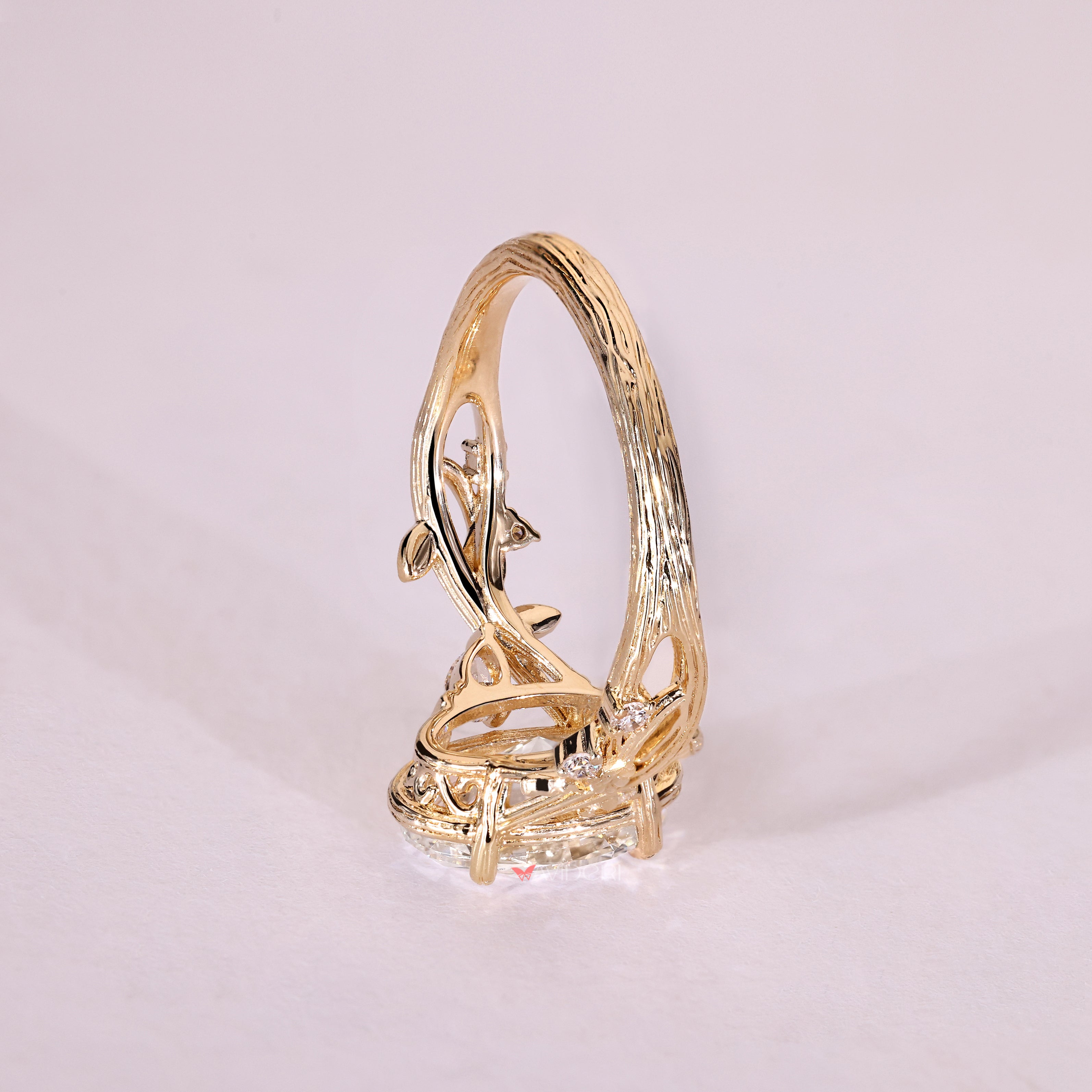Oval center diamond ring with pear side stone accents
