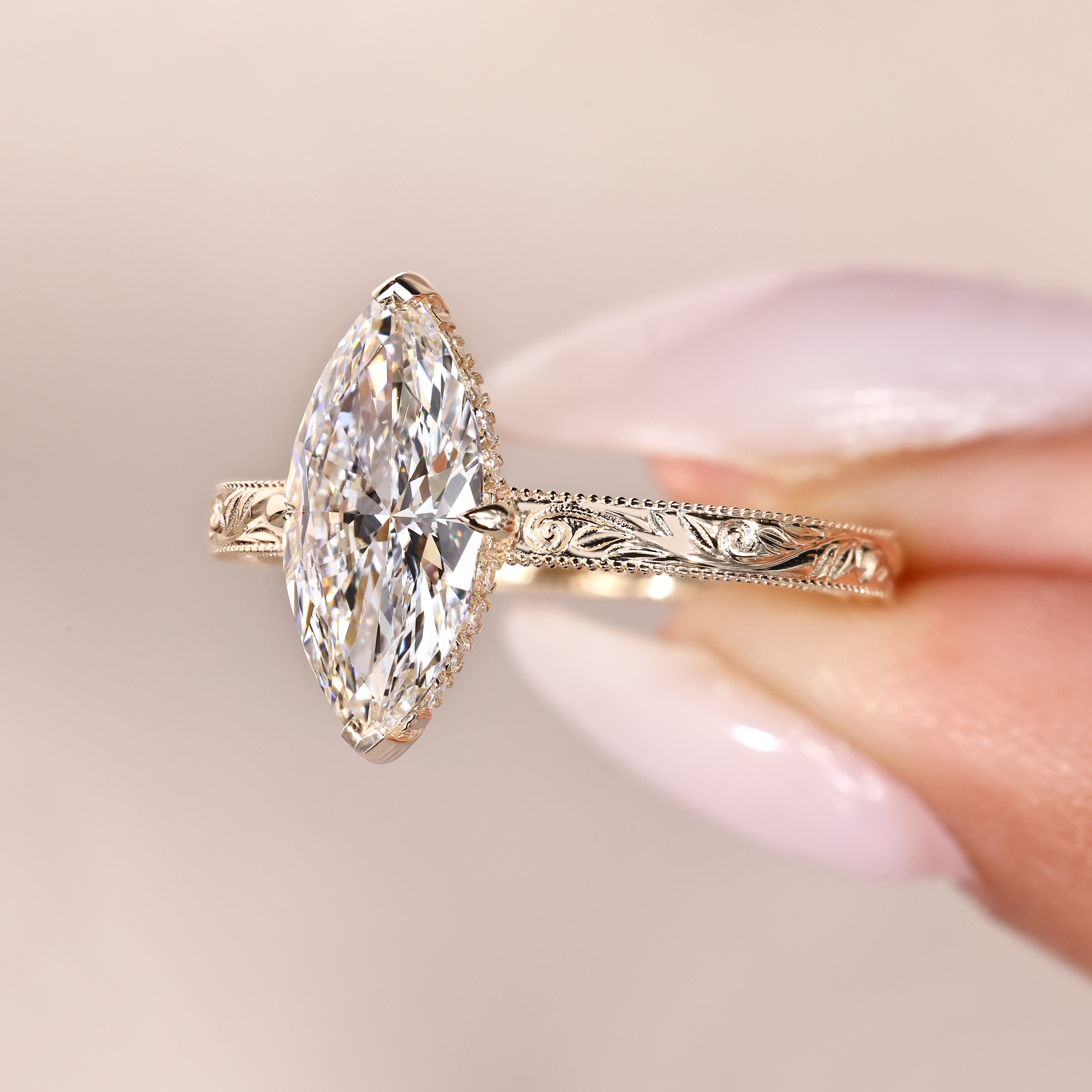 Marquise diamond ring with two V and claw prongs.
