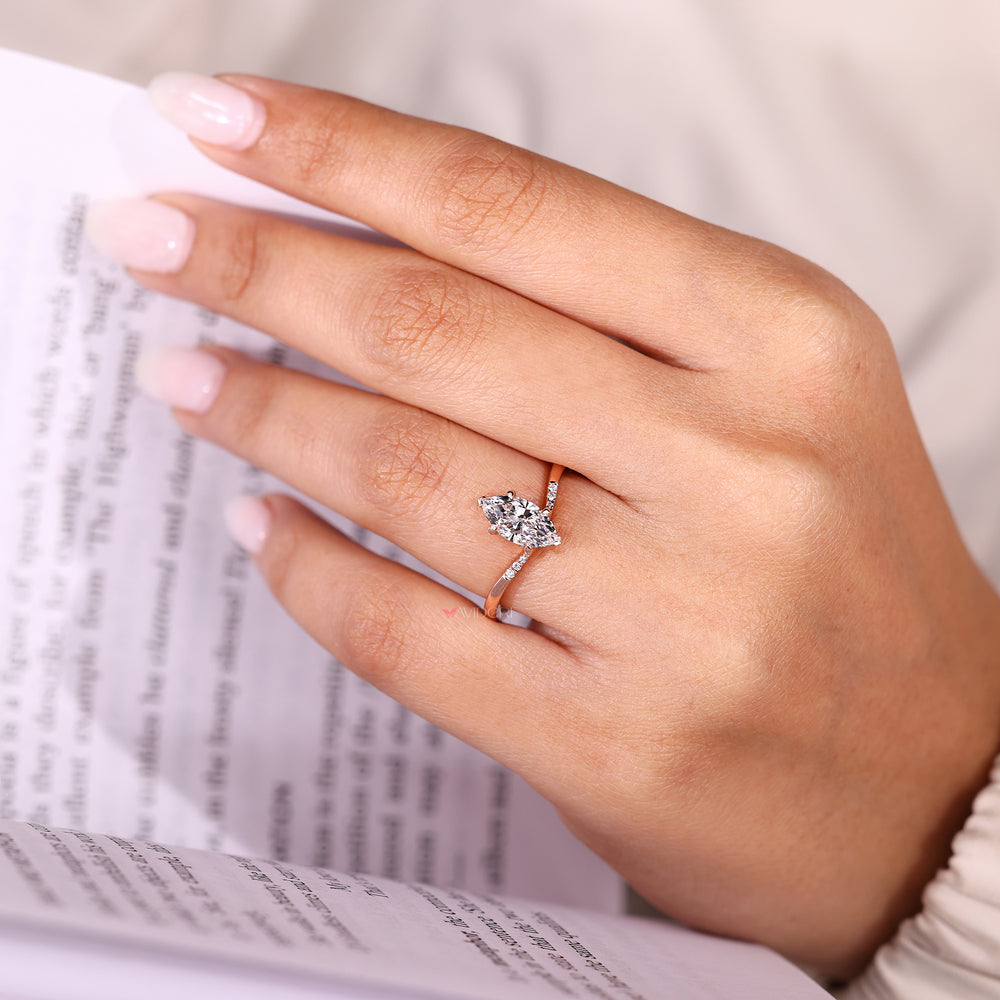 Marquise diamond ring with pave style band.
