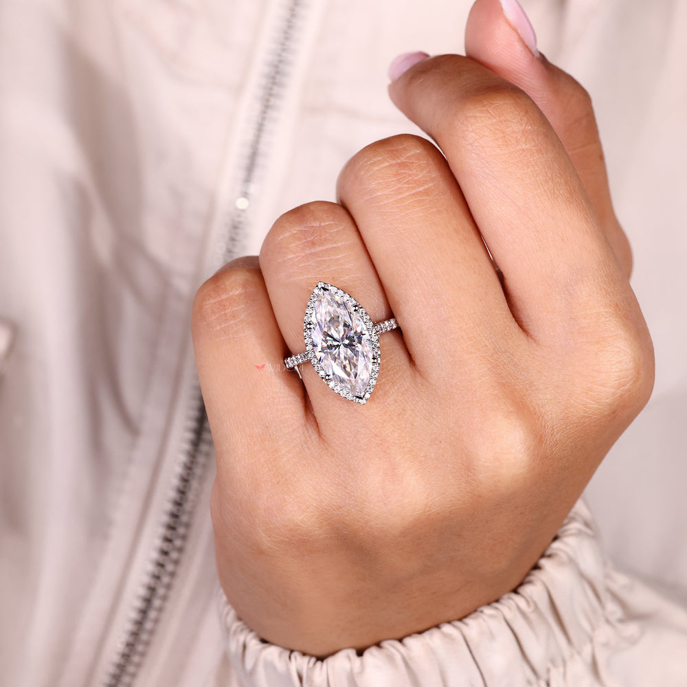 Marquise ring with cathedral setting and bridge accent.