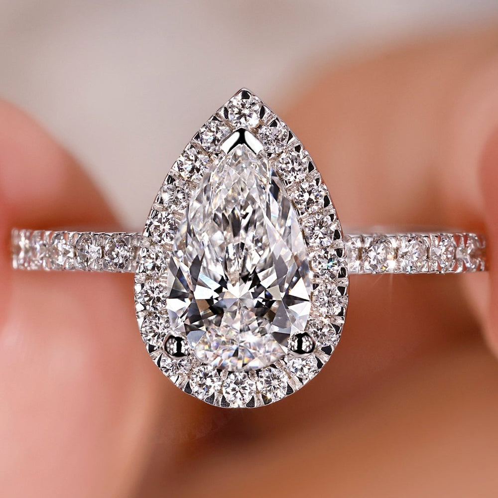Pear shaped engagement ring with pave setting in white gold.