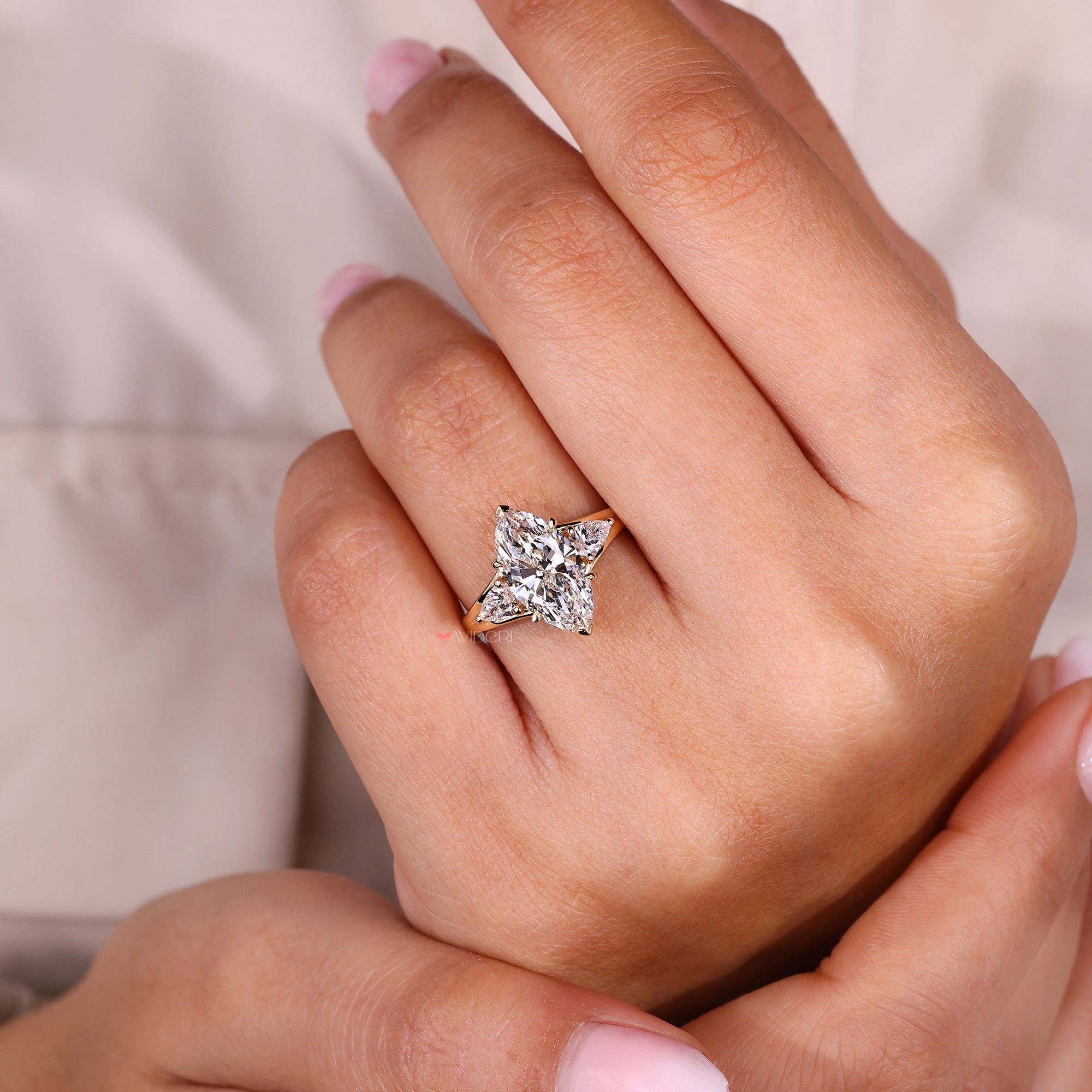 Pear side stone engagement ring with marquise center.