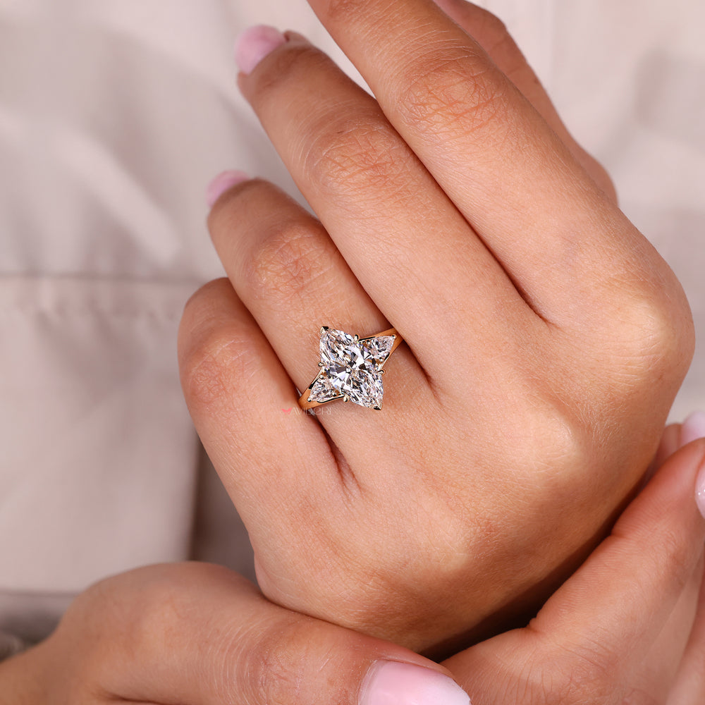 Pear side stone engagement ring with marquise center.
