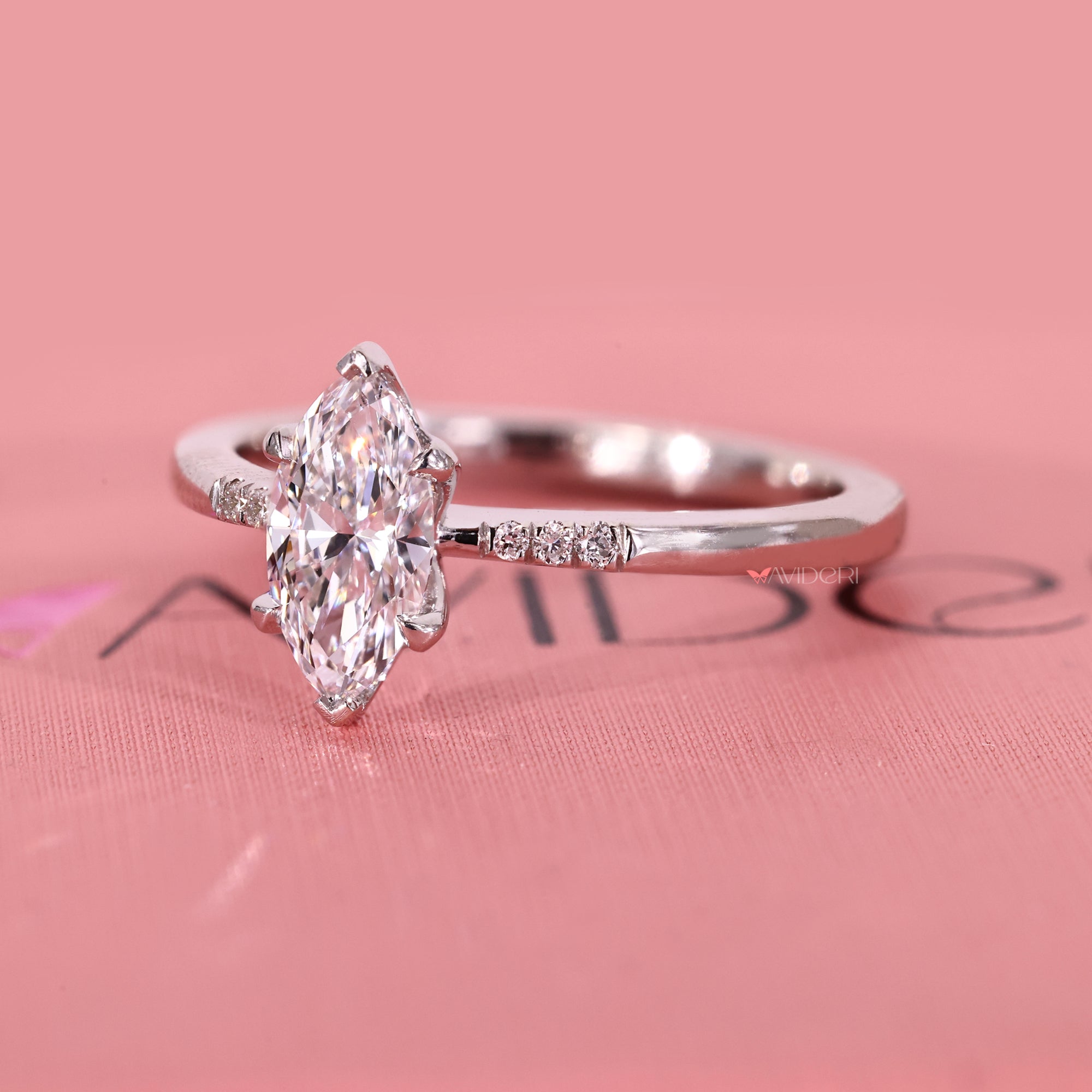 Lab grown diamond ring with marquise cut center and side stones.