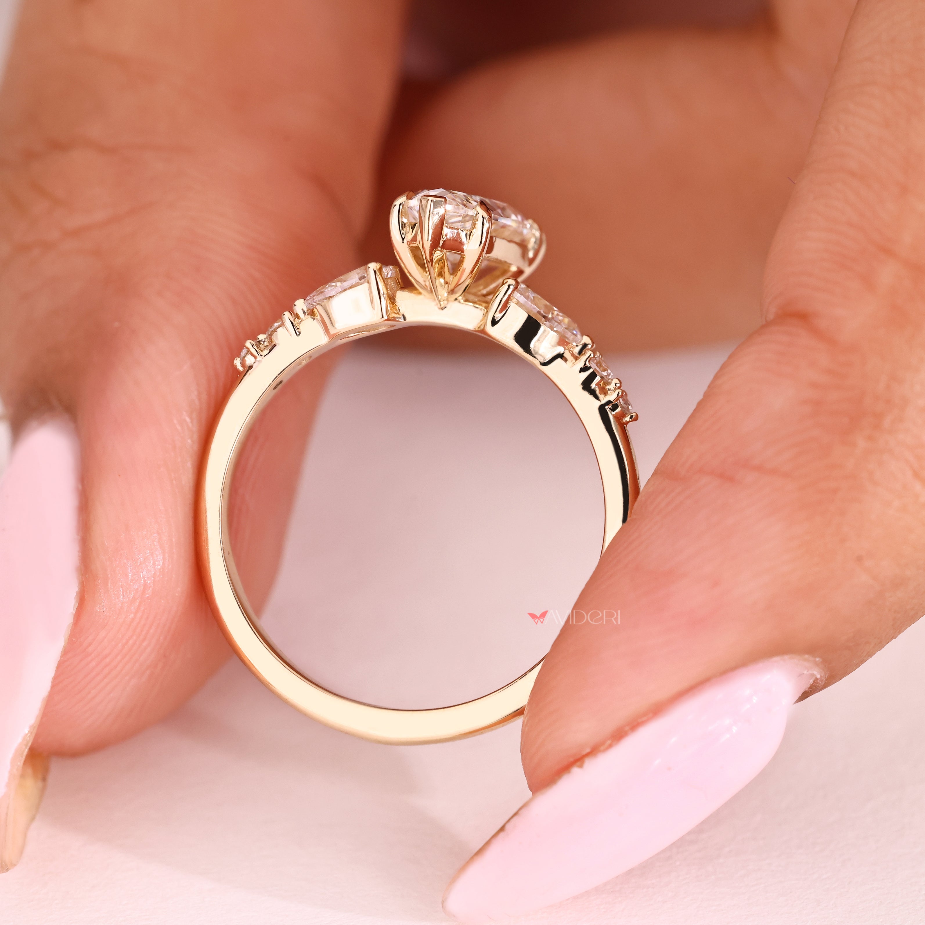 Lab grown pear diamond ring with five claw prongs
